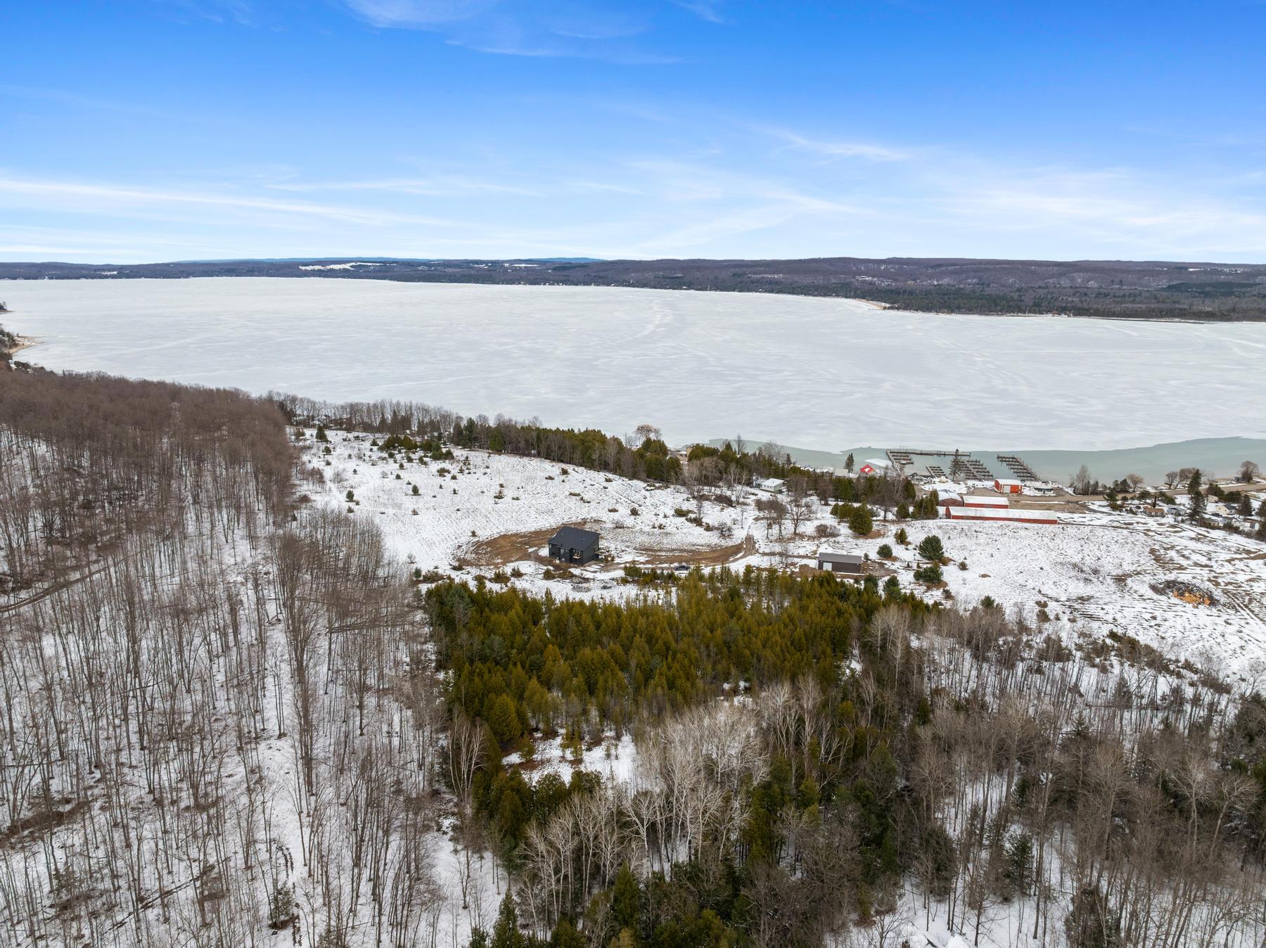 Lakefront home on Lake Charlevoix with winter calm water