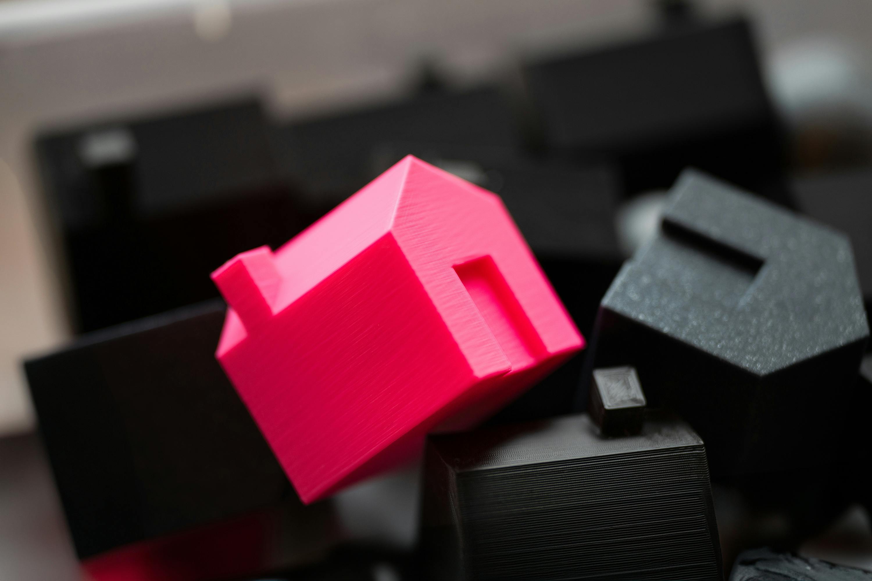 Home plastic icons, one in red | Homes for sale in Springfield