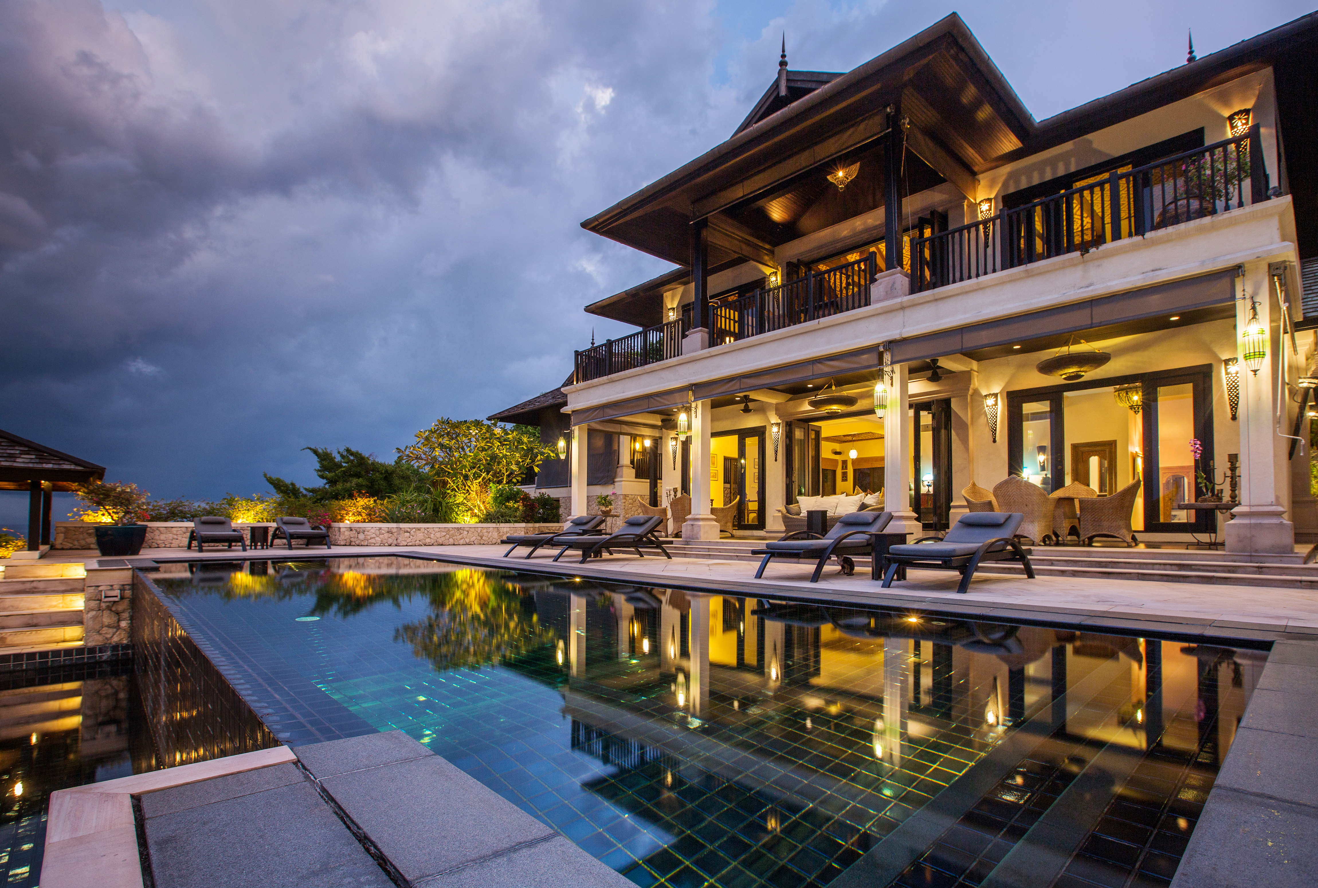 Luxury home with in-ground pool, dark night sky