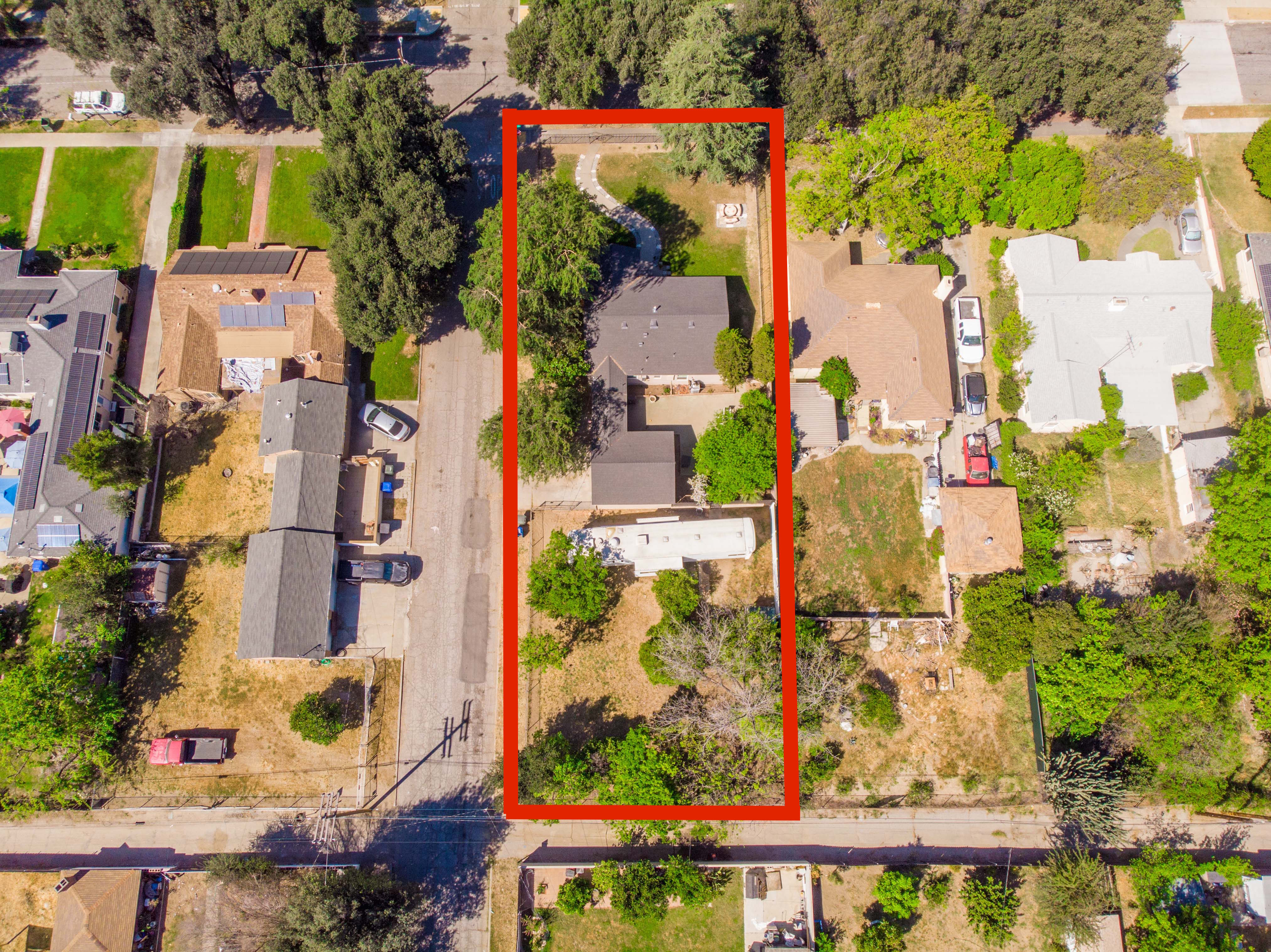 Aerial view of 2803 Ladera Rd in North San Bernardino highlighting the large 1/4 acre lot with home and expansive backyard outlined