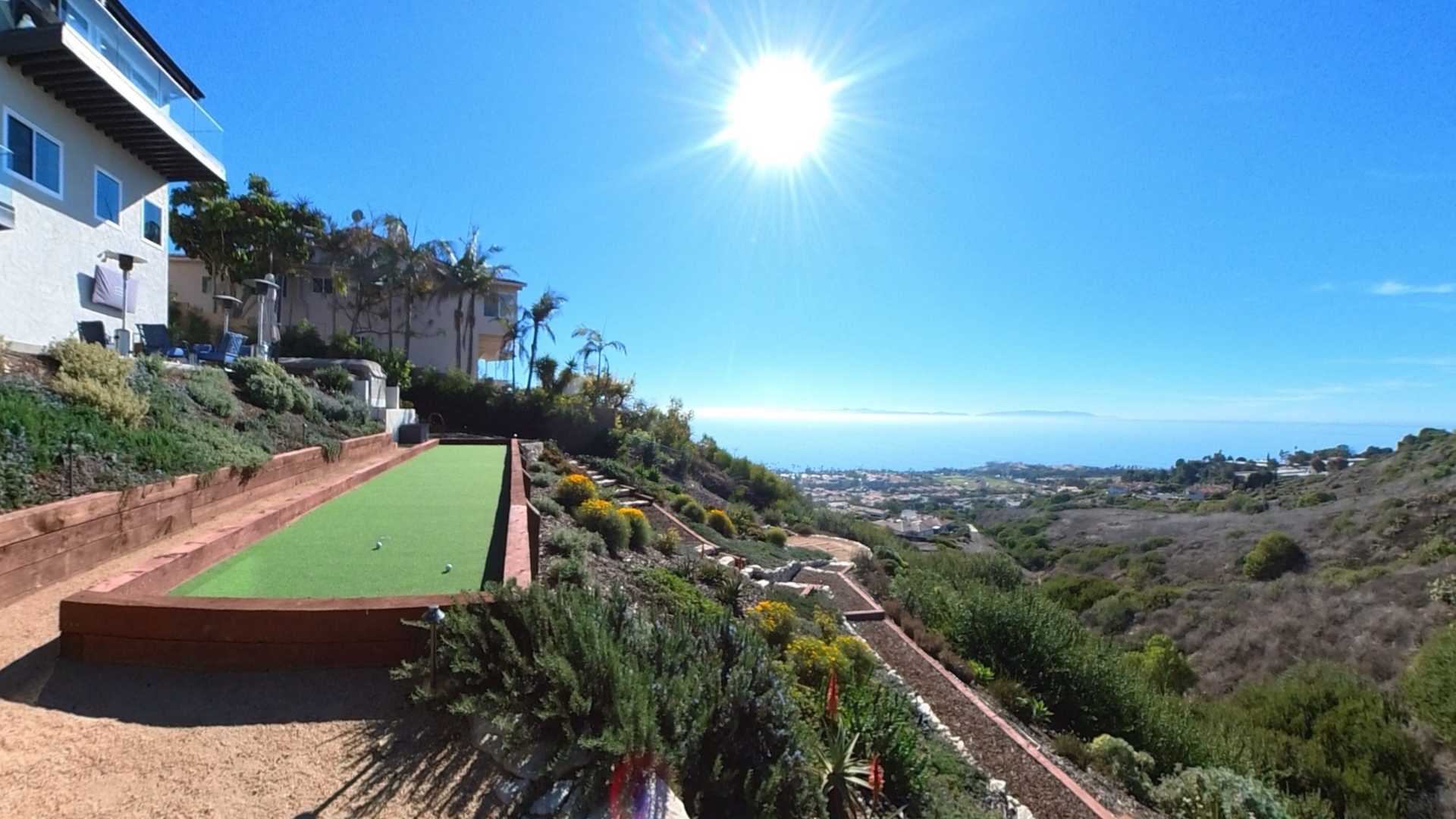 Panoramic Pacific Ocean and Catalina Island views from 31311 Marne Drive in Rancho Palos Verdes, overlooking the coastal hills and landscaped backyard.