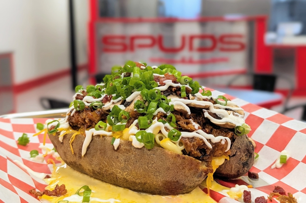 Spuds Potato Bar serving up loaded potatoes in Montgomery By Community Impact header image.