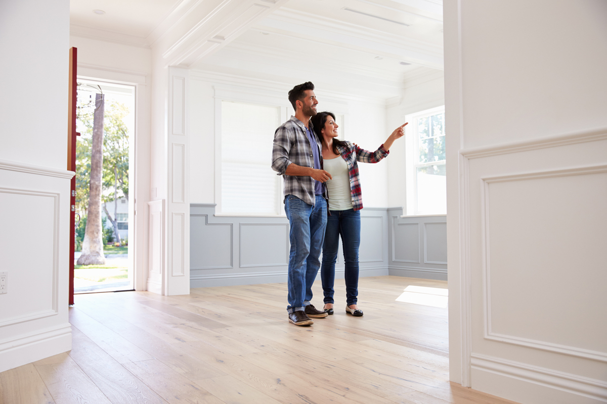 A home buyer touring a bright living room during a real estate showing