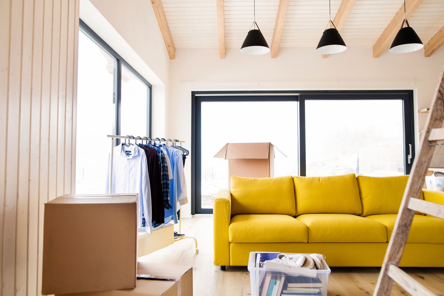 Moving boxes in a bright living room as homeowners prepare to buy and sell at the same time