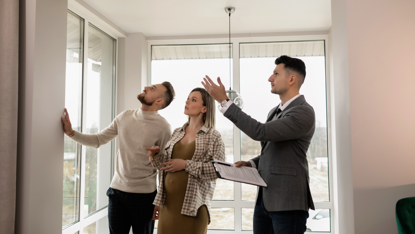 Real estate agent showing a couple around a home during a first-time homebuyer tour in Indiana