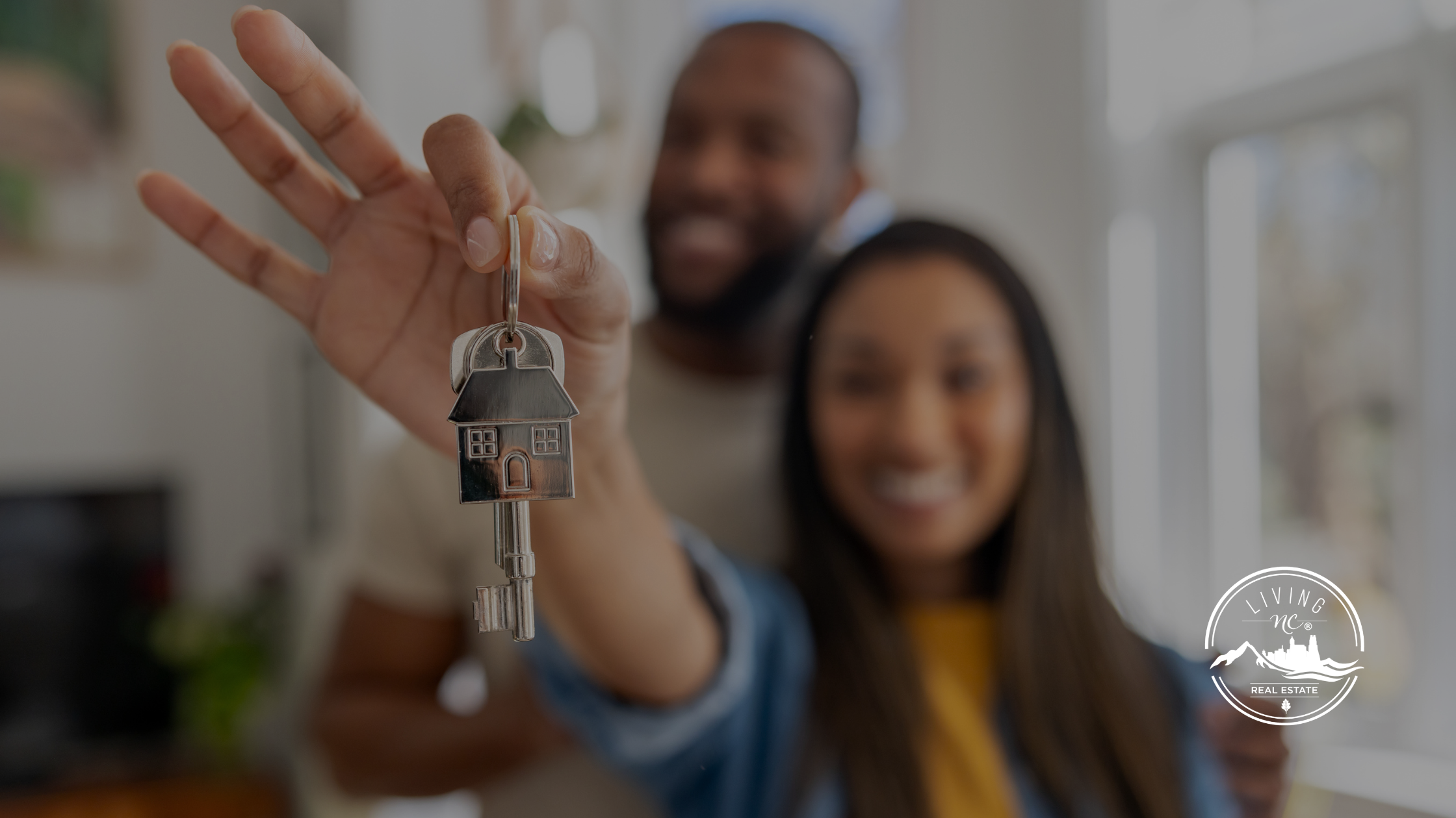 First-time homebuyers reviewing paperwork while buying a house in North Carolina