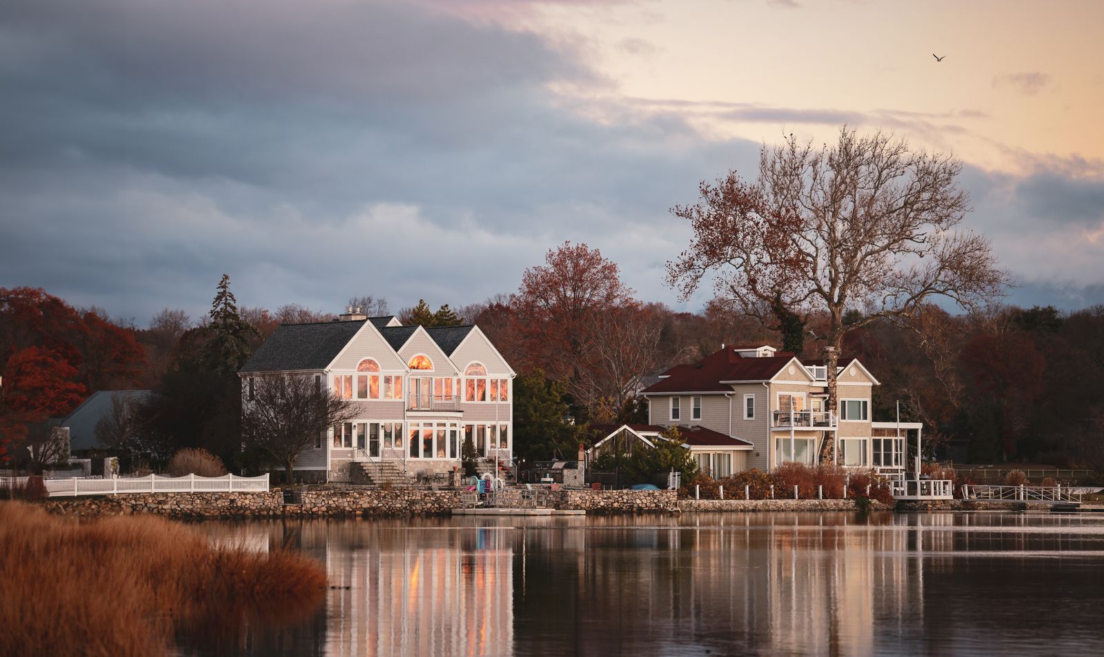 Waterfront New England homes at autumn sunset - moving to NH from New York