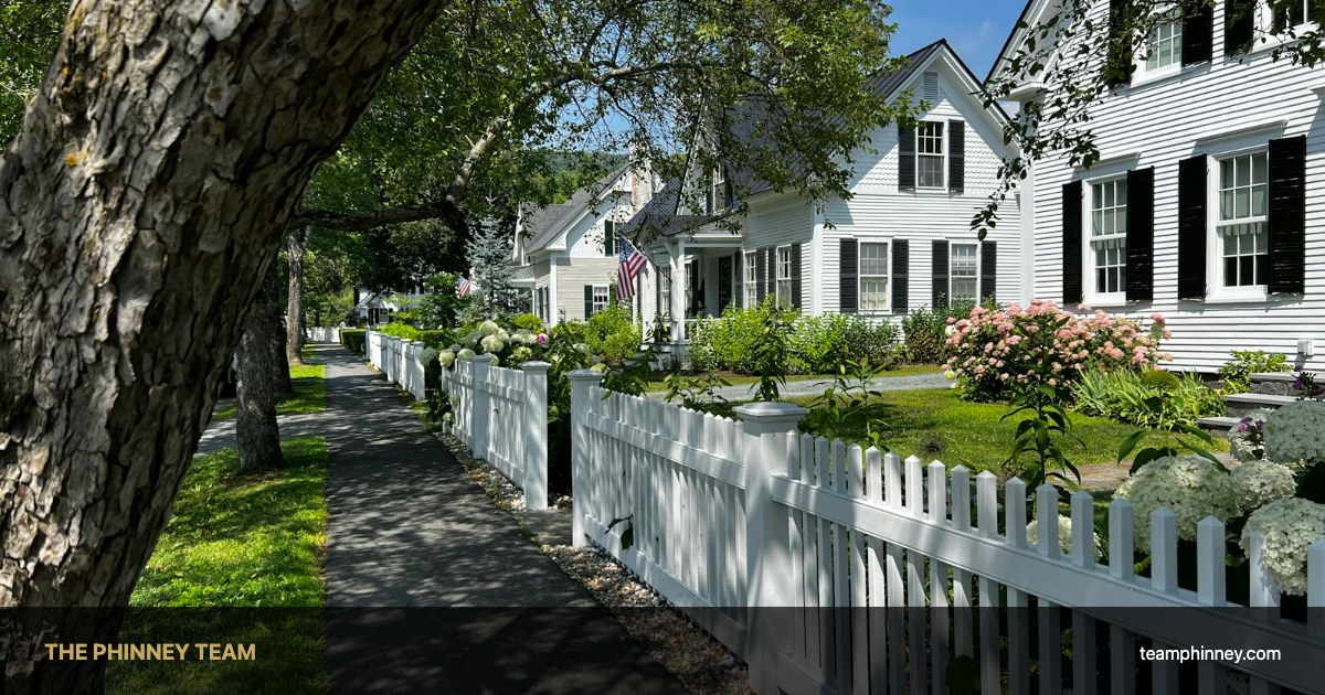 New England street with white picket fence — Bedford vs Manchester NH neighborhood comparison