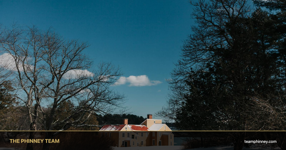 Best neighborhoods in Bedford NH: classic New England colonial home under blue sky