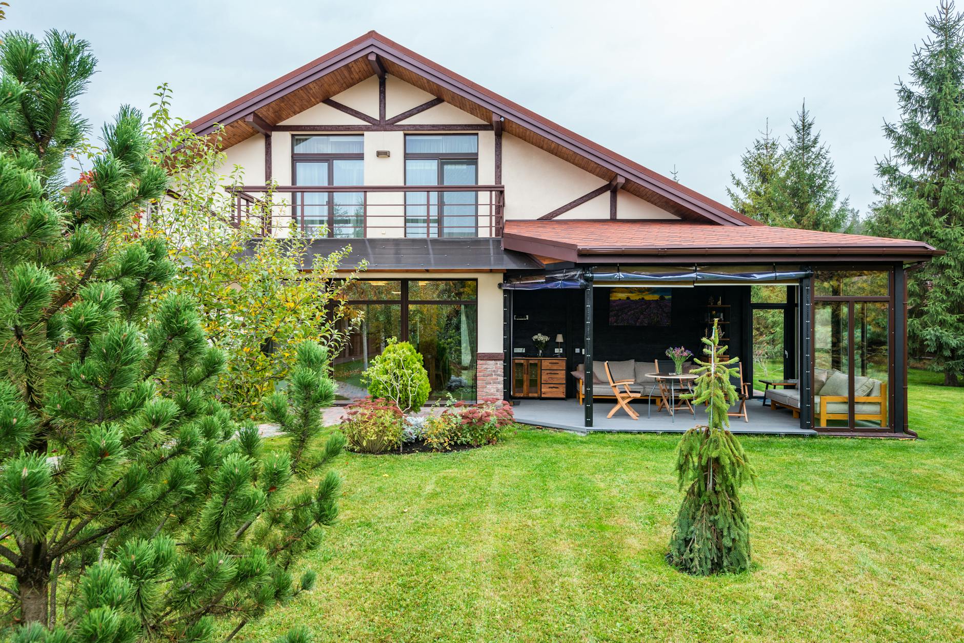 Large gabled New England family home with a covered patio and lush green summer backyard — Amherst NH schools and homes for families