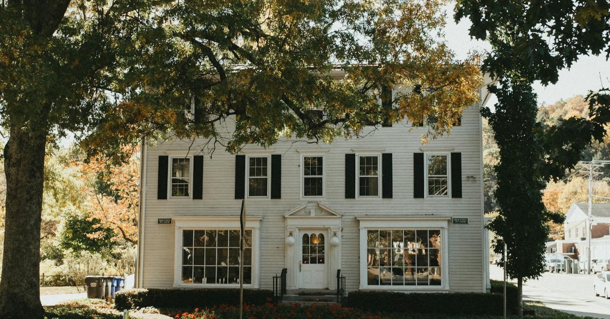 Classic New England colonial home with autumn foliage — Derry NH real estate market 2026