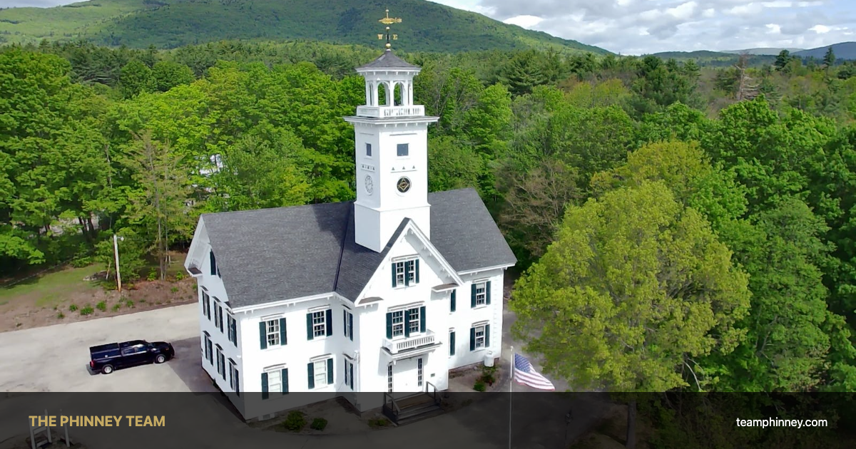Aerial view of a New Hampshire town hall surrounded by greenery — Concord NH real estate spring 2026 market update