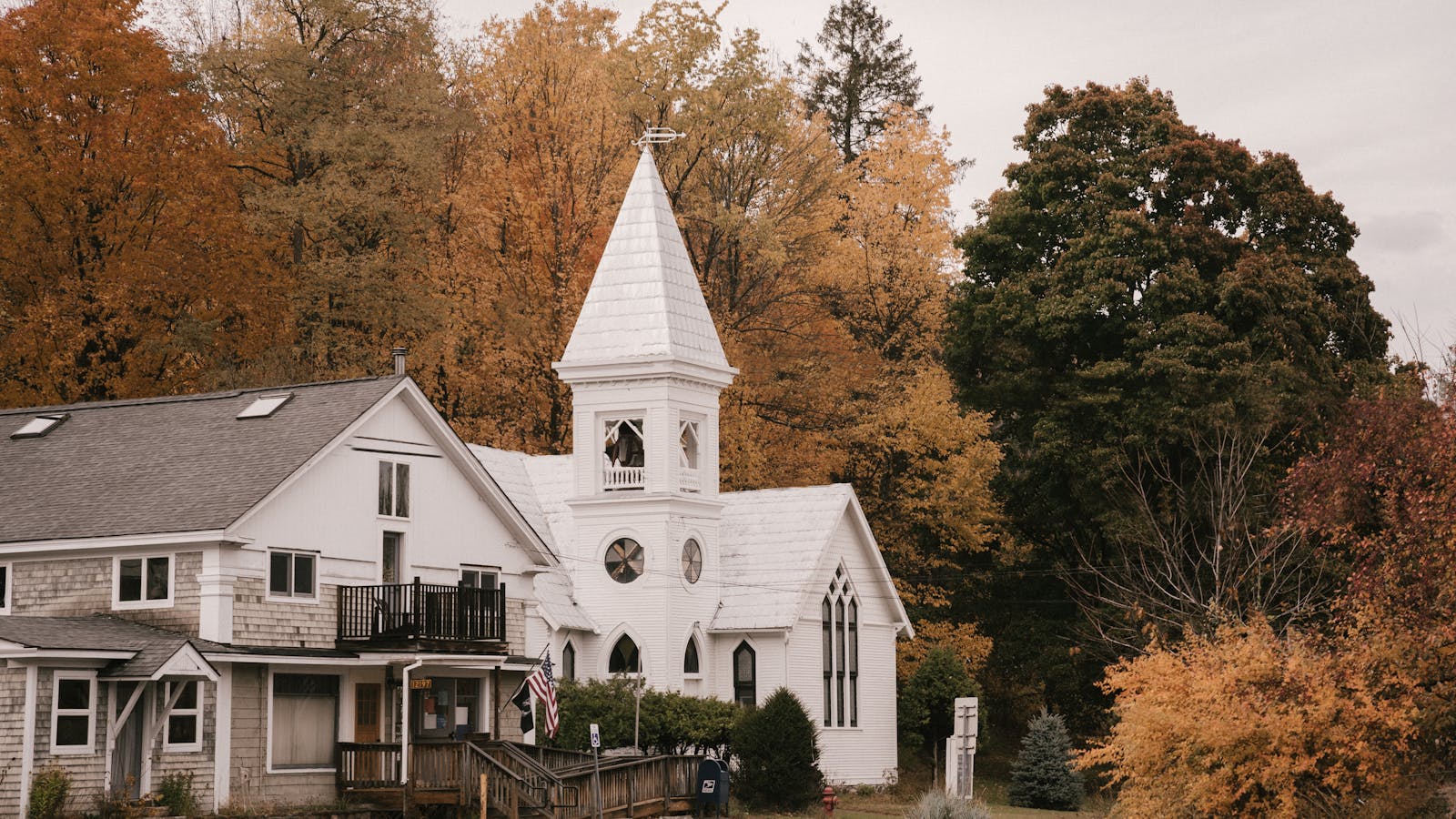 White New England home with autumn yellow trees - Goffstown NH neighborhoods homes for sale