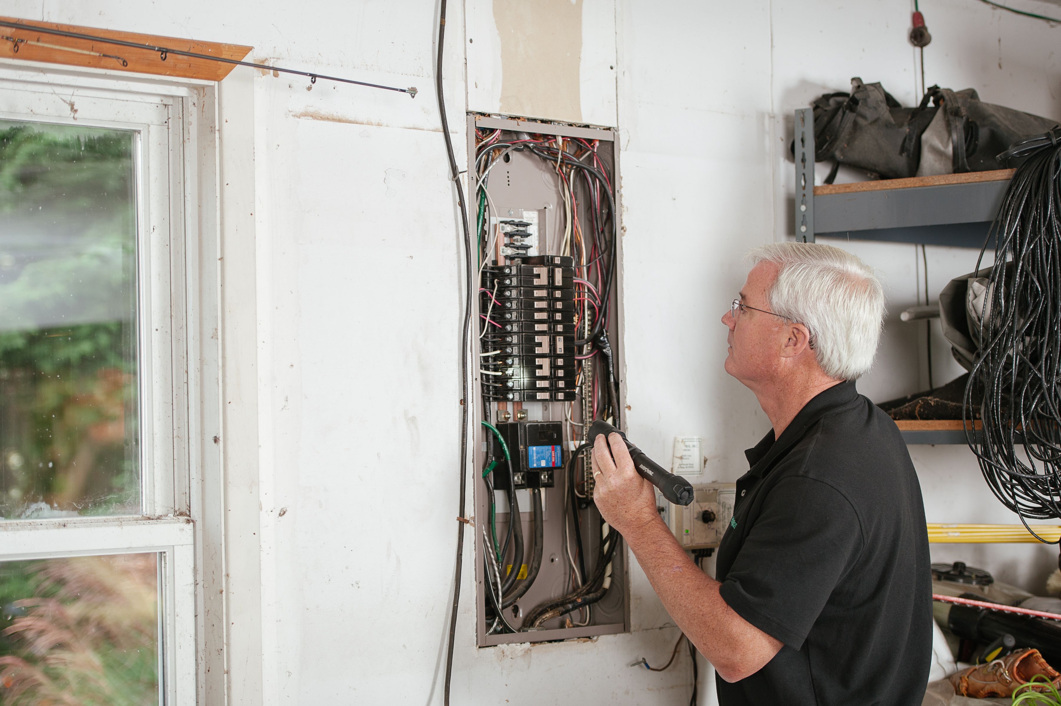 Man inspecting an electrical panel