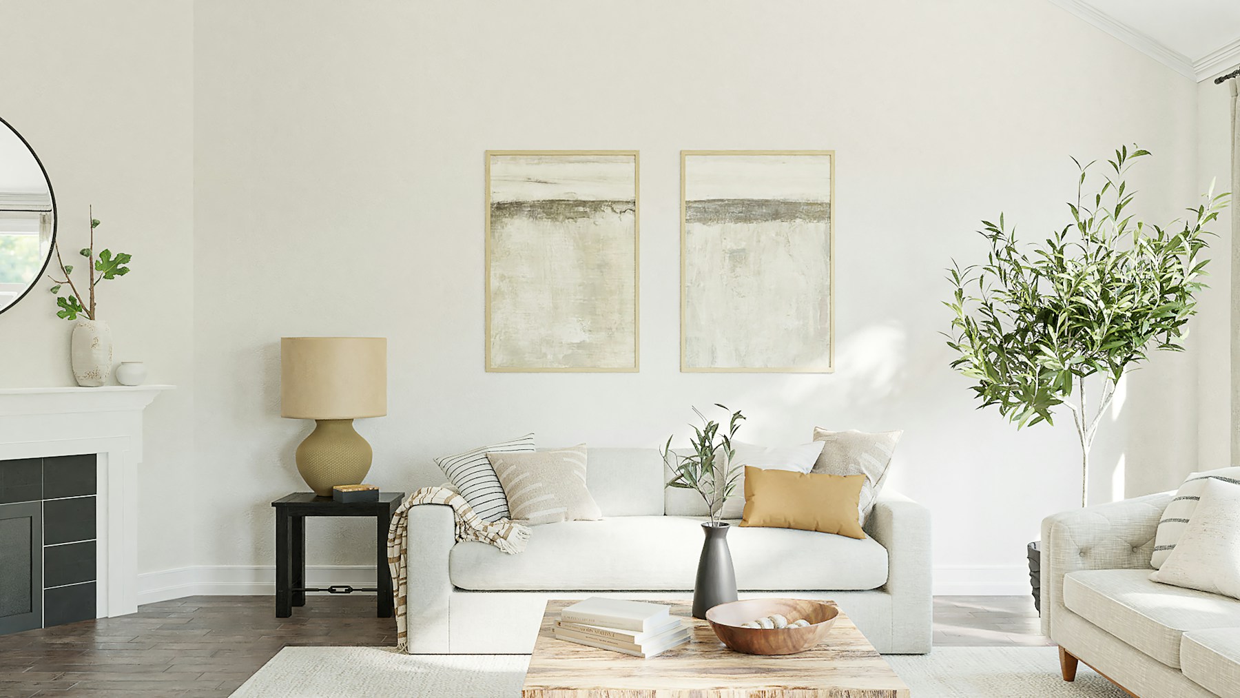 Bright minimalist living room with a cream sofa, wood coffee table, twin abstract art prints, tall indoor tree, and a black-tiled fireplace