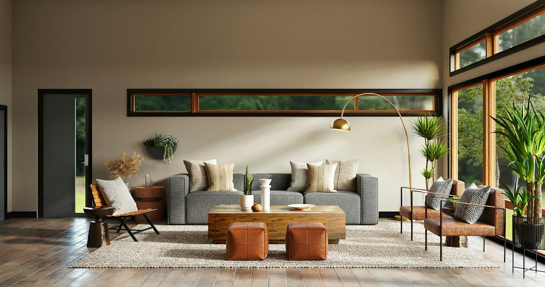 Modern quiet-luxury living room with a grey sofa, cognac leather armchairs, gold arc floor lamp, and floor-to-ceiling windows overlooking greenery
