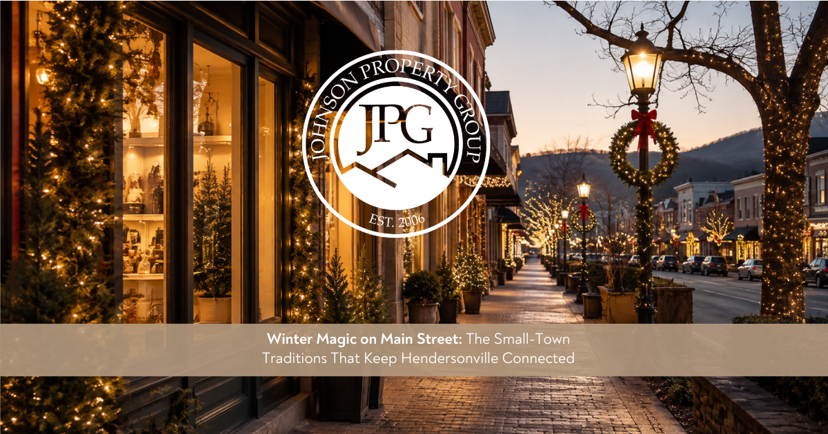 Johnson Property Group branded winter lifestyle graphic showing Hendersonville Main Street with warm lights, charming storefronts, soft evening glow, and a refined small-town holiday feel.