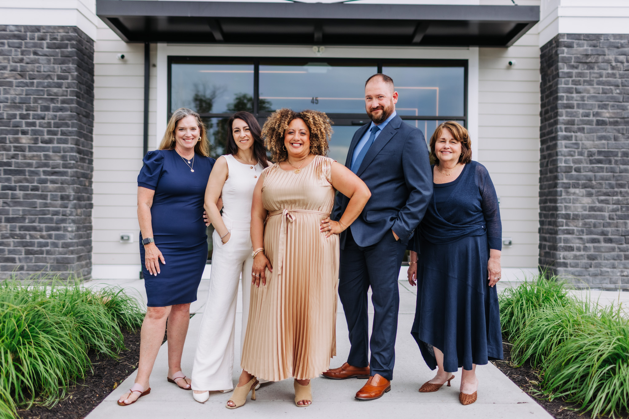 The Melina Bradley Real Estate Team in front of their office