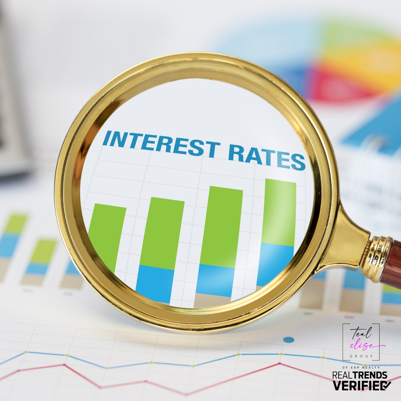 Magnifying glass over ‘Interest Rates’ and rising bar graph, representing real estate market trends. 