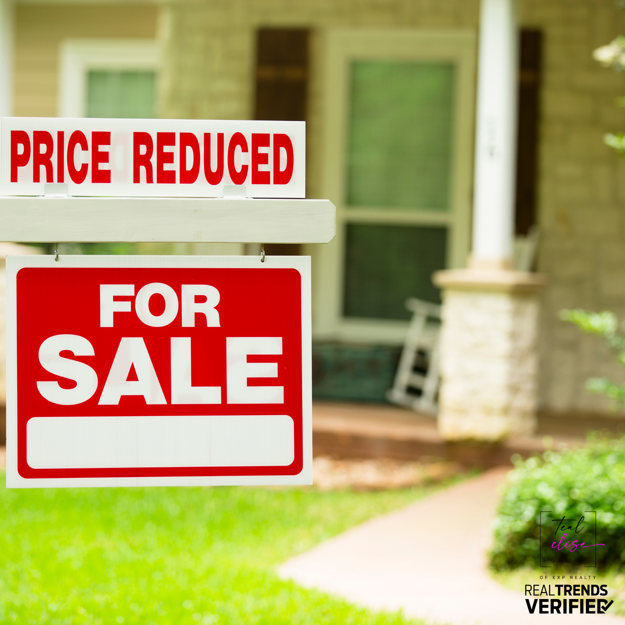 Red and white real estate sign reading 