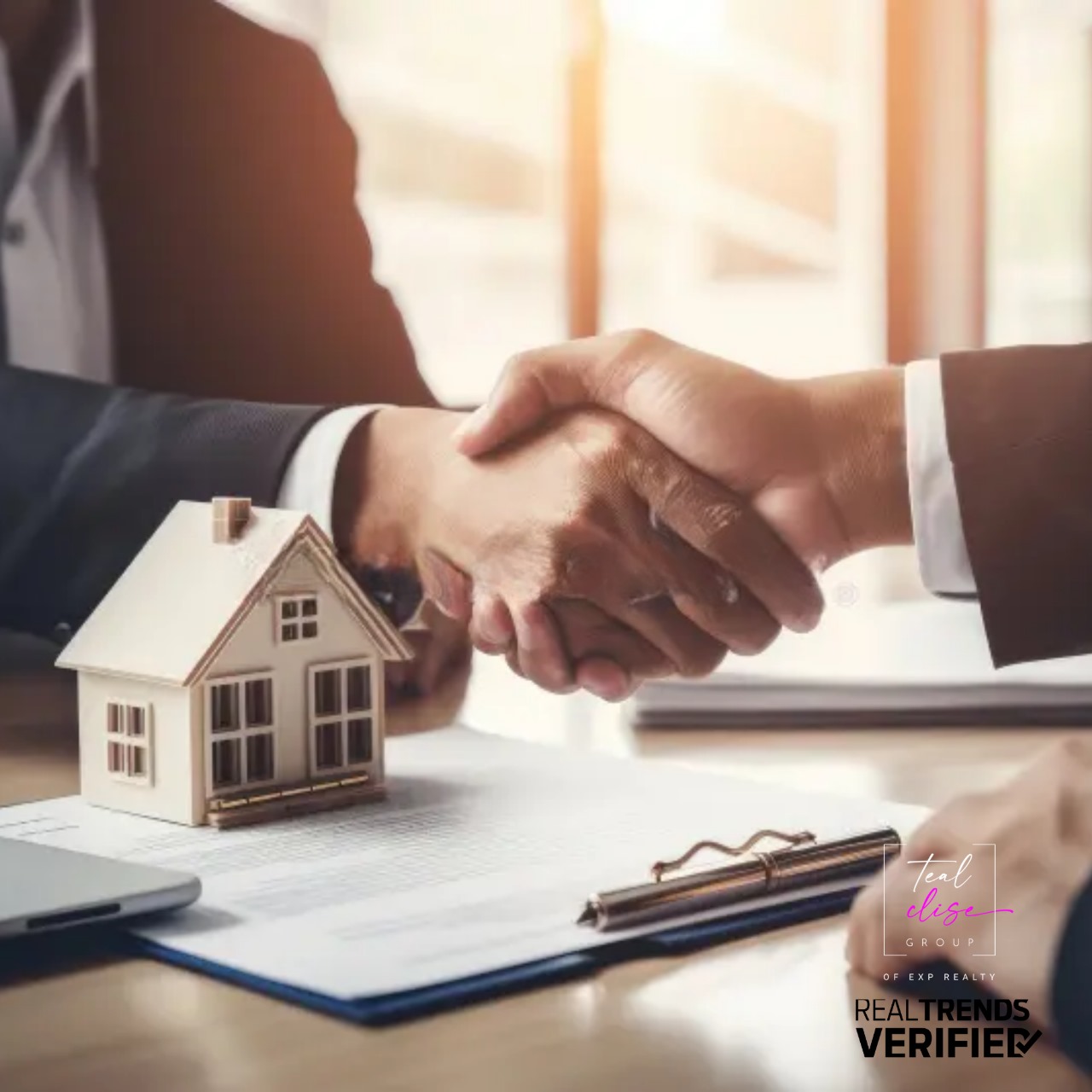 Two people shaking hands over a real estate contract, symbolizing a successful home deal in Maryland.
