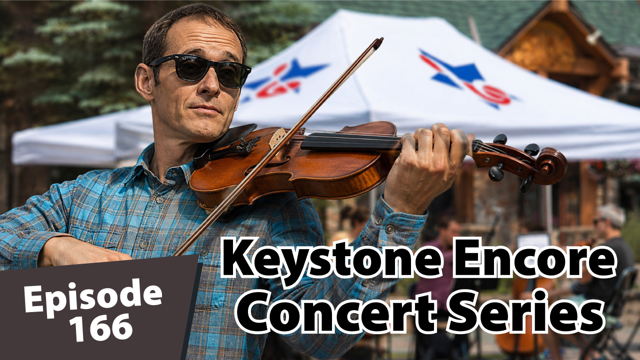 Matt Dayton plays a violin in sunglasses at an outdoor Keystone concert, with musicians performing under a white tent in a mountain village setting behind him.