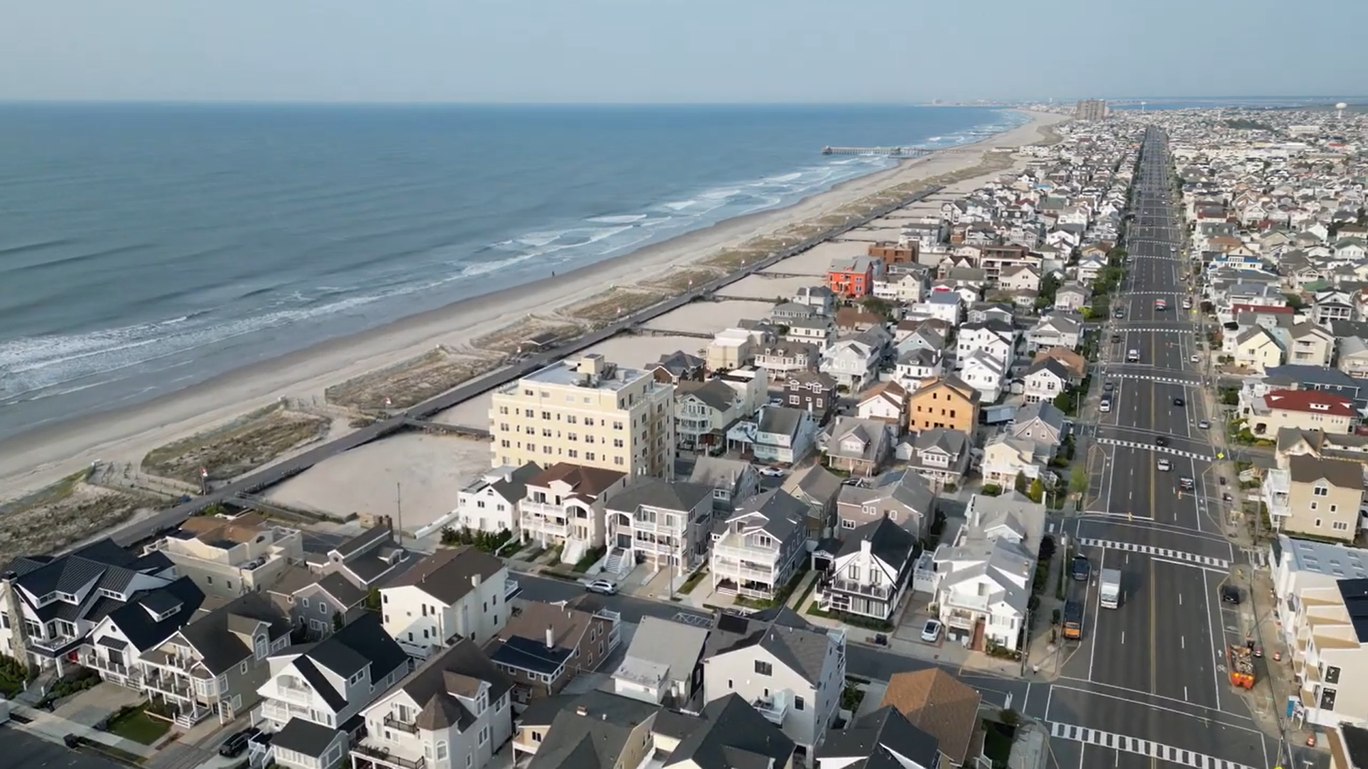 Aerial view of luxury coastal real estate and beachfront vacation homes along the boardwalk in Ventnor City, NJ.