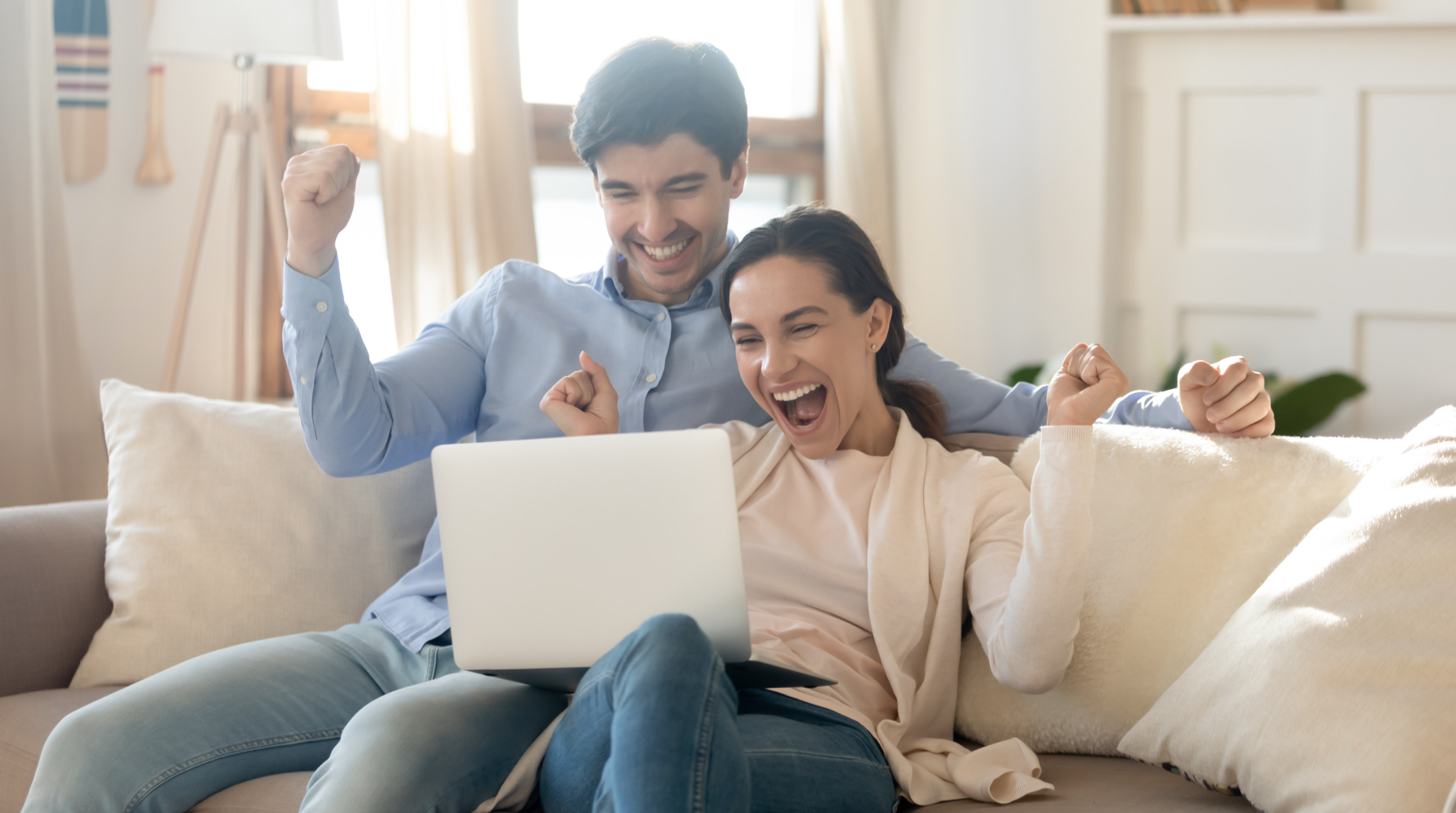 Couple cheering on a couch