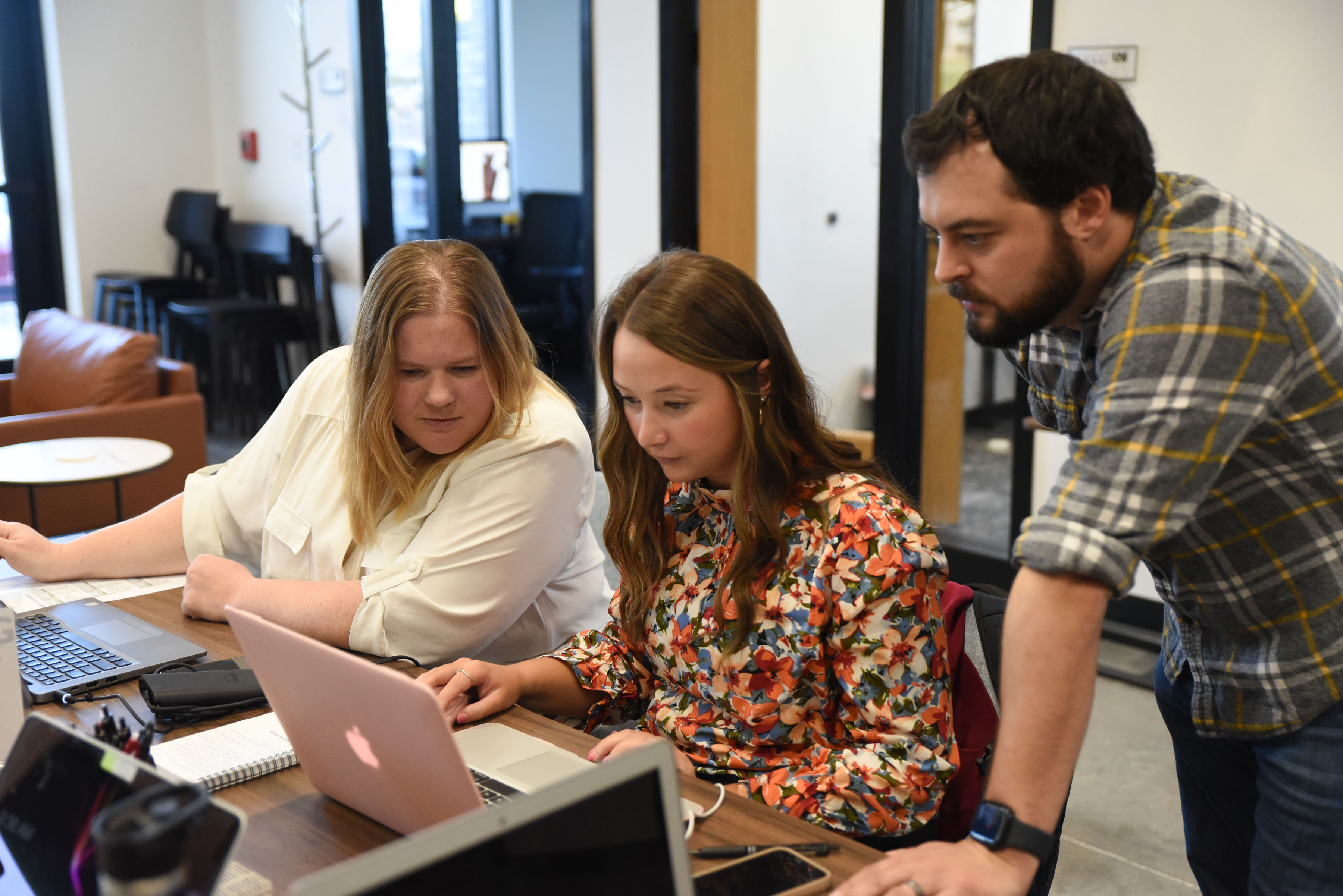 Agents gathered around a laptop