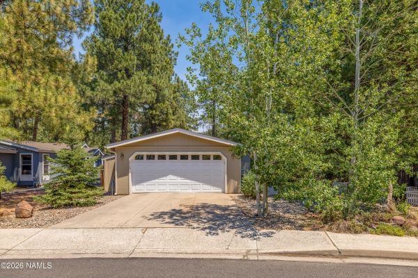 2460 W Rio Grande Ct sits among mature Ponderosa pines in Flagstaff's Railroad Springs community