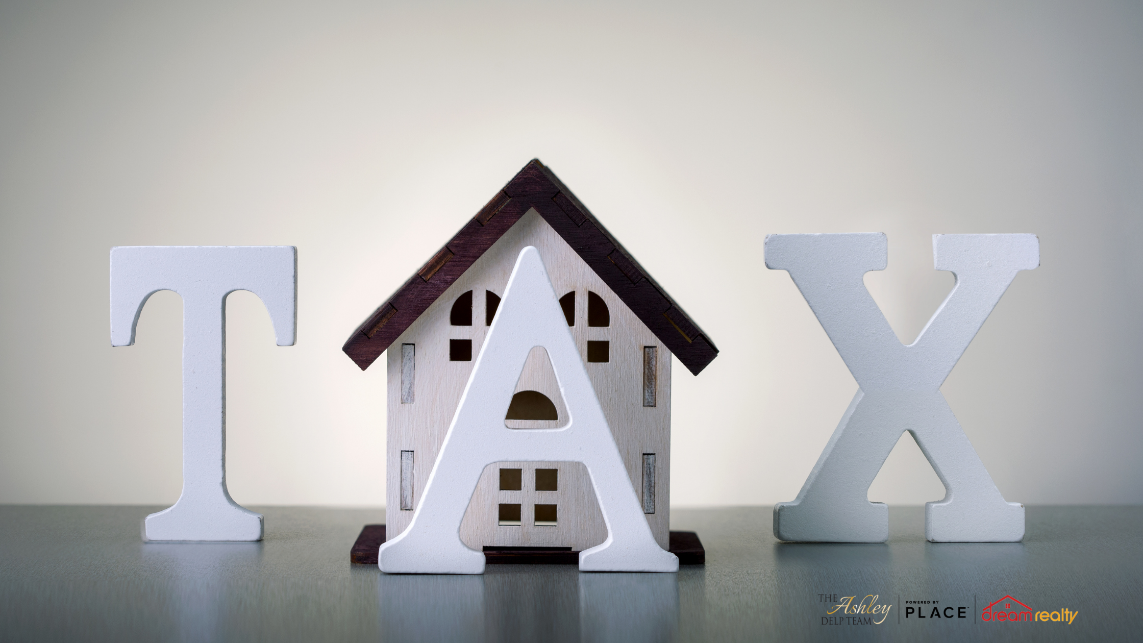 Tax in Wooden Blocks with Home Behind It