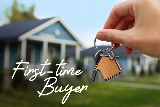 A first time buyer holding the key to their new home