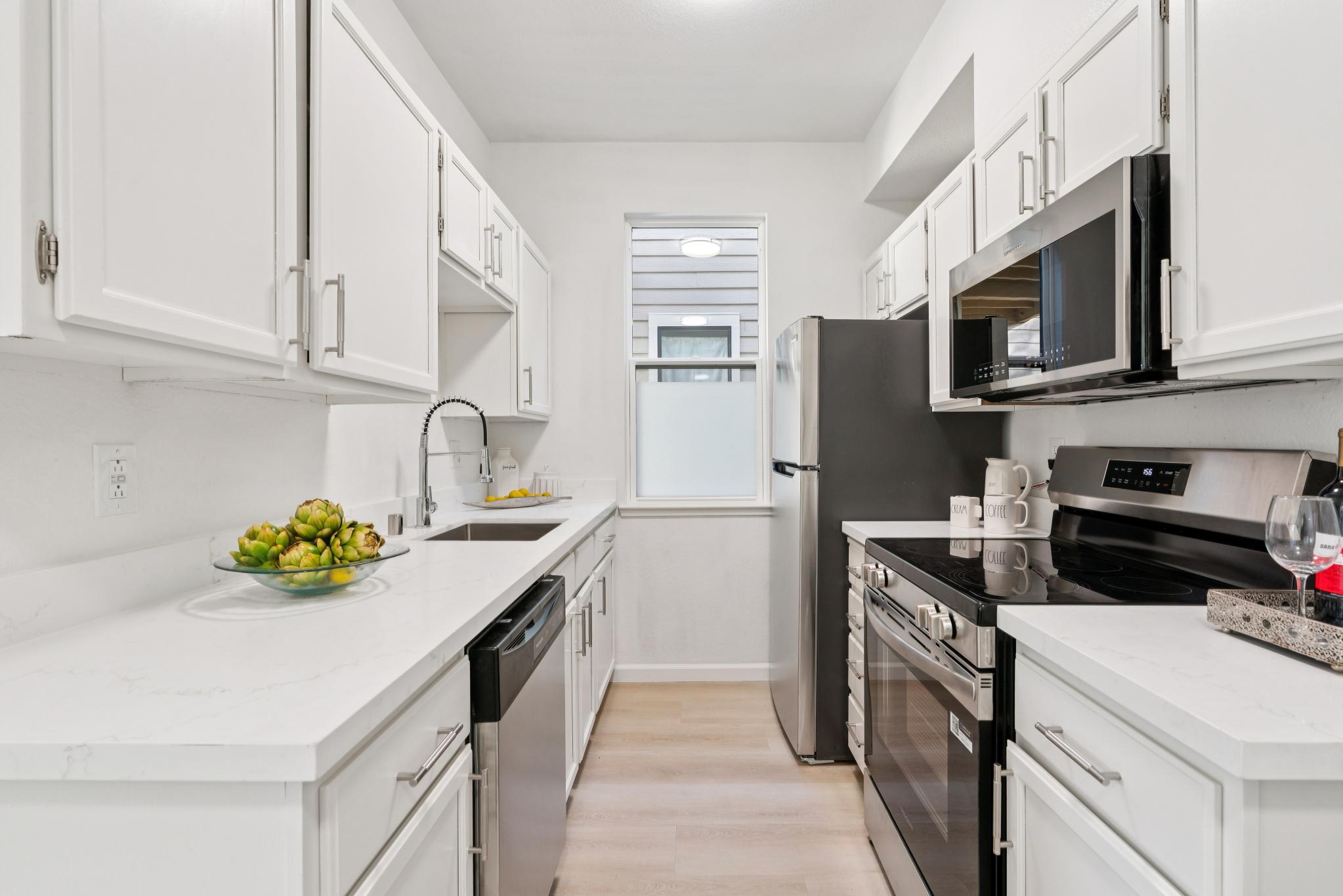 Updated kitchen with white cabinets and stainless appliances at 79 Lakeshore Ct, Richmond