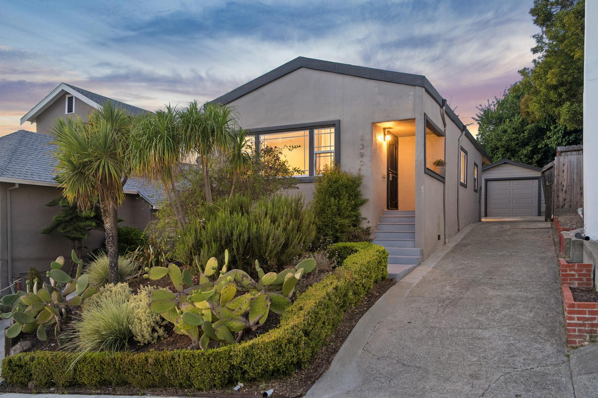 Front exterior and long driveway at 1390 E 31st St in Bella Vista Hill, Oakland, CA