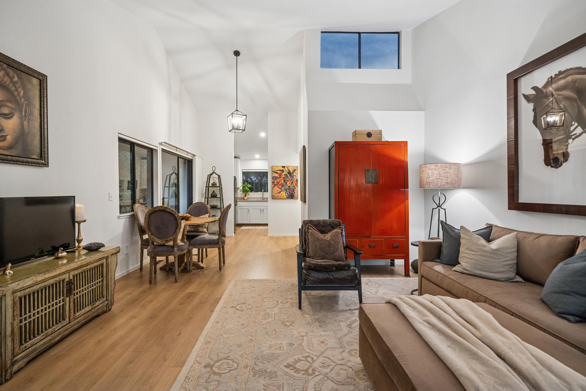 Open living and dining area with tall ceiling and upper window at 45 Corte Real #1