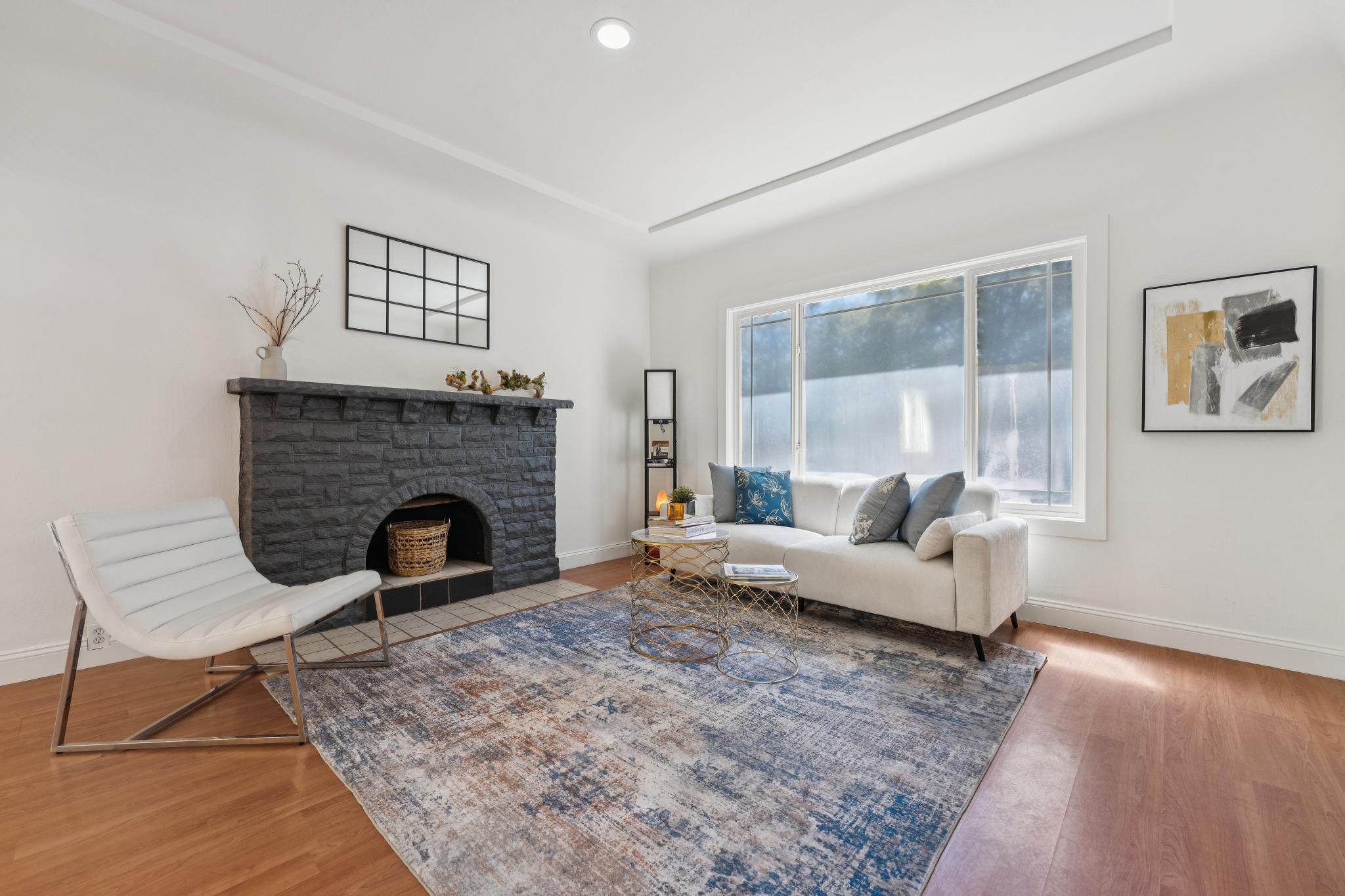 Living room at 220 Marina Way in Richmond with wood flooring and a fireplace surround