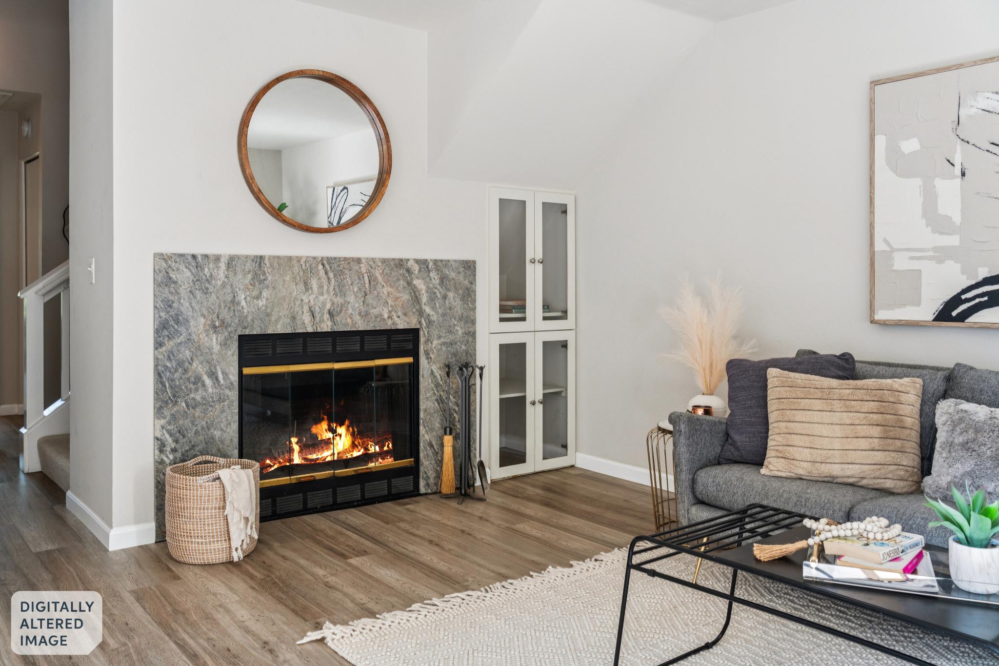 Living room fireplace with full stone surround at 214 Bayside Ct in Richmond, California