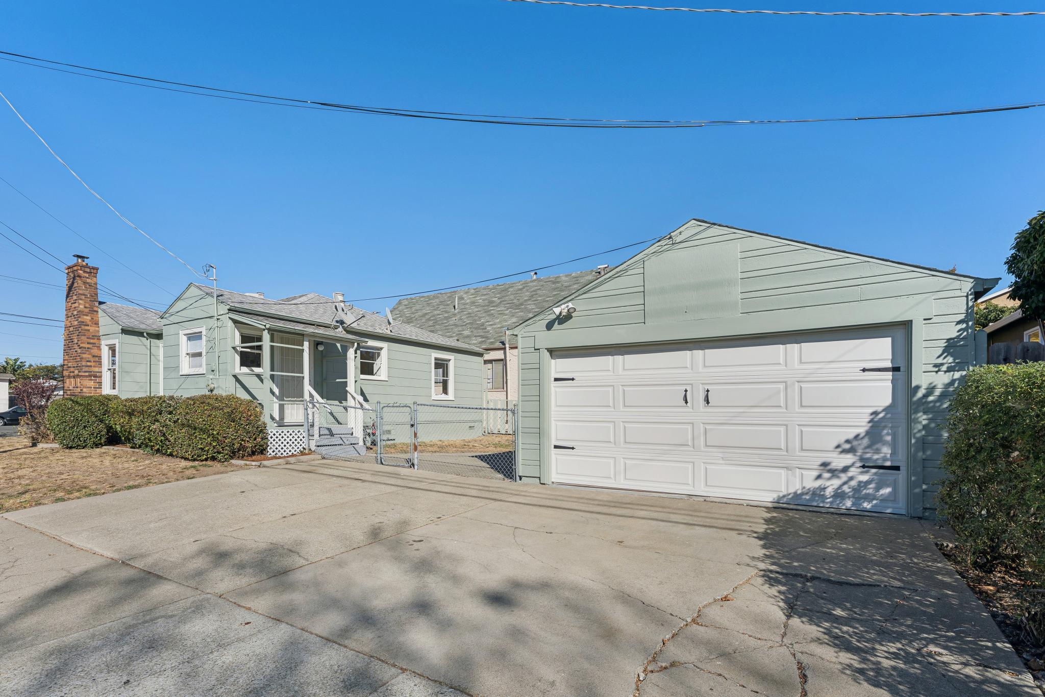 Detached two-car garage and driveway beside the house at 3400 McBryde Ave in North and East, Richmond, CA
