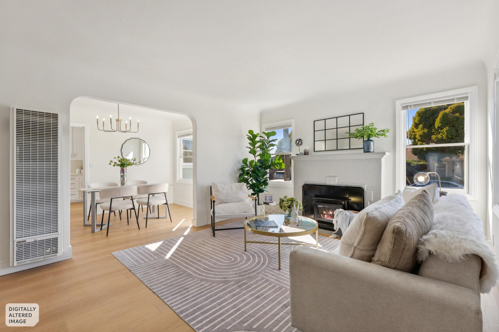 Bright living room with fireplace and dining room beyond at 3400 McBryde Ave in North and East, Richmond, CA