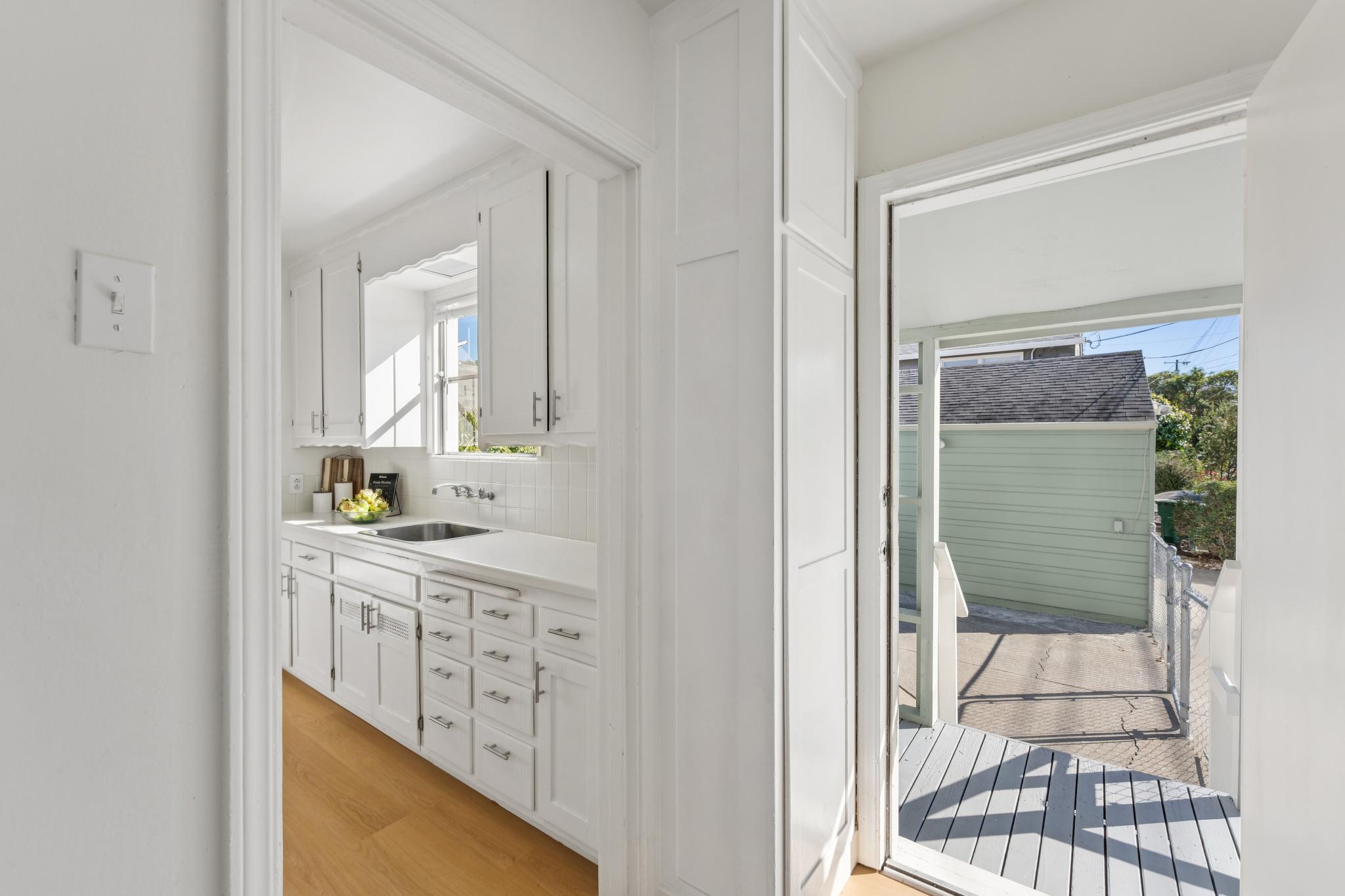 Laundry room with a back door opening toward the yard at 3400 McBryde Ave in North and East, Richmond, CA