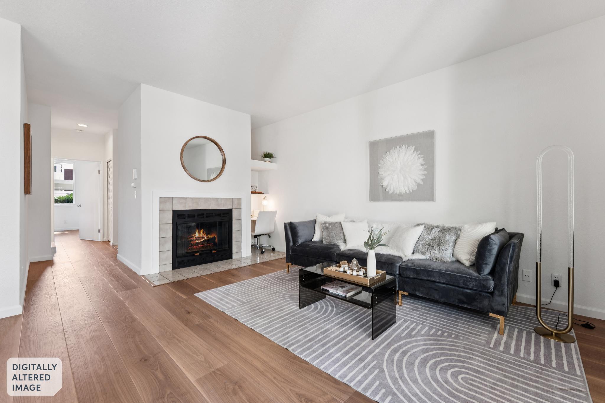 Staged living room with fireplace lit at 145 Bayside Ct in Marina Bay, Richmond