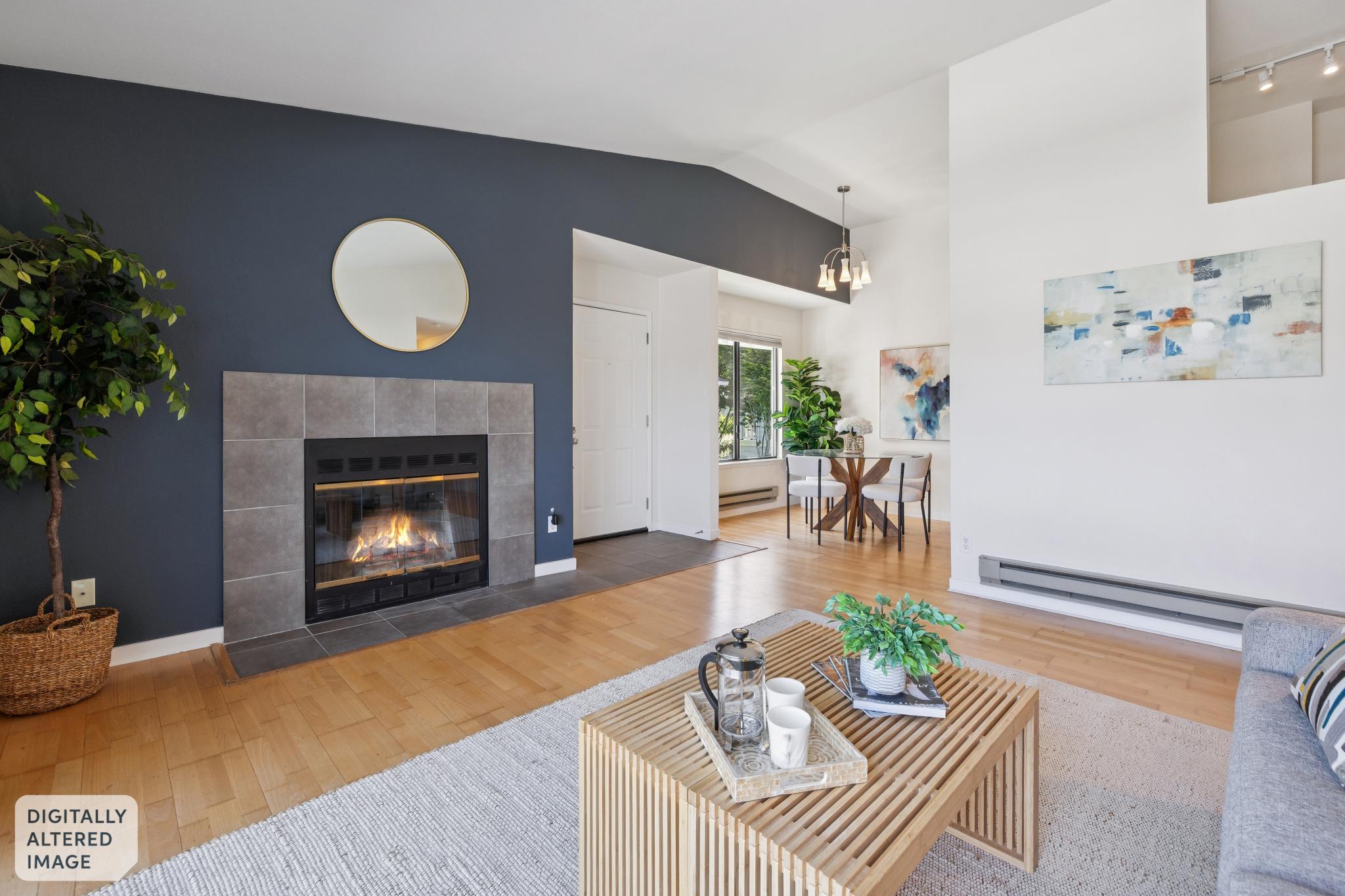 Staged living room with fireplace lit at 6 Schooner Ct in Marina Bay, Richmond
