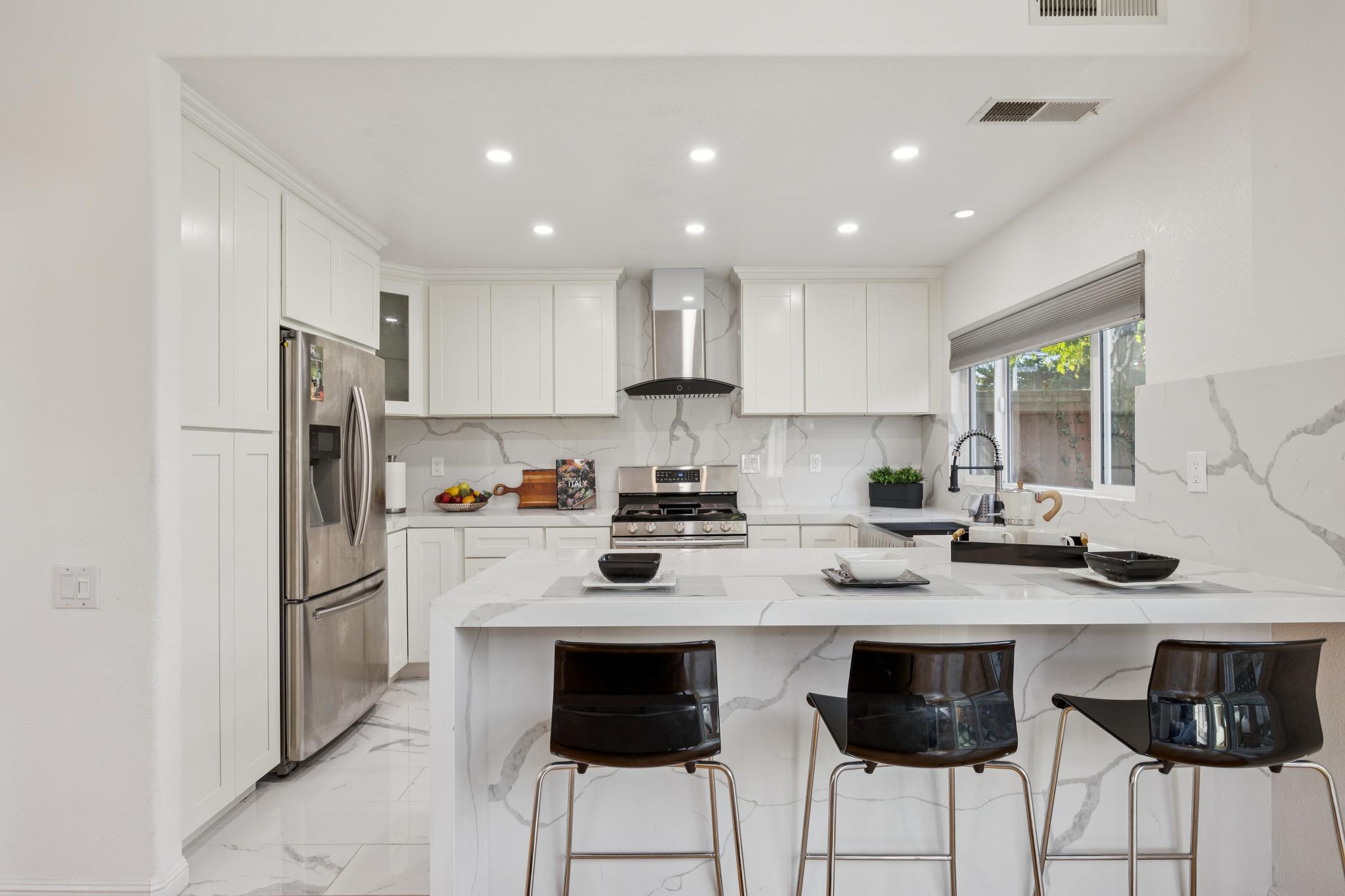 Updated white kitchen with marble countertops and stainless steel appliances at 65 Seagull Dr in Richmond