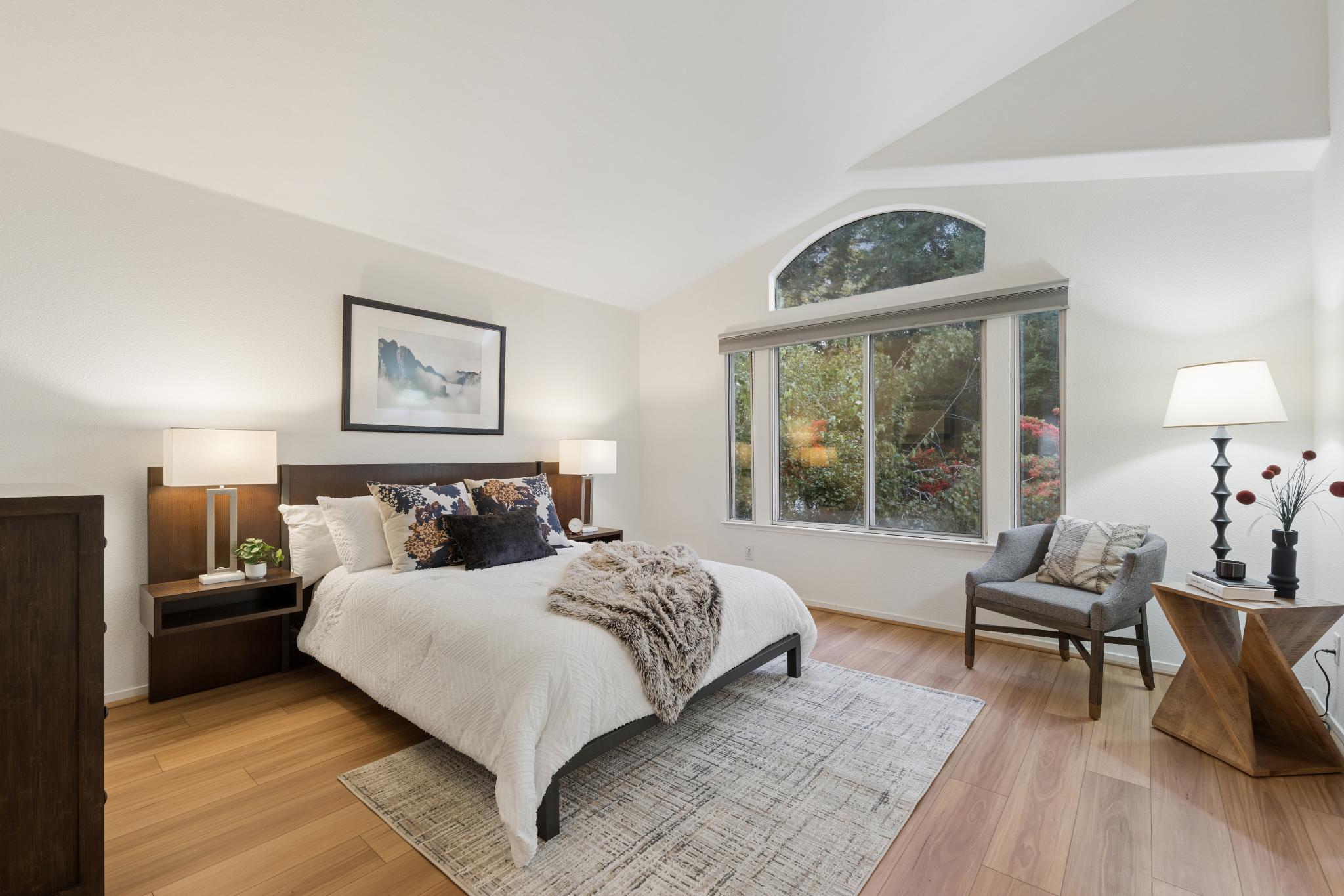 Primary bedroom with vaulted ceiling and arched window at 65 Seagull Dr in Richmond