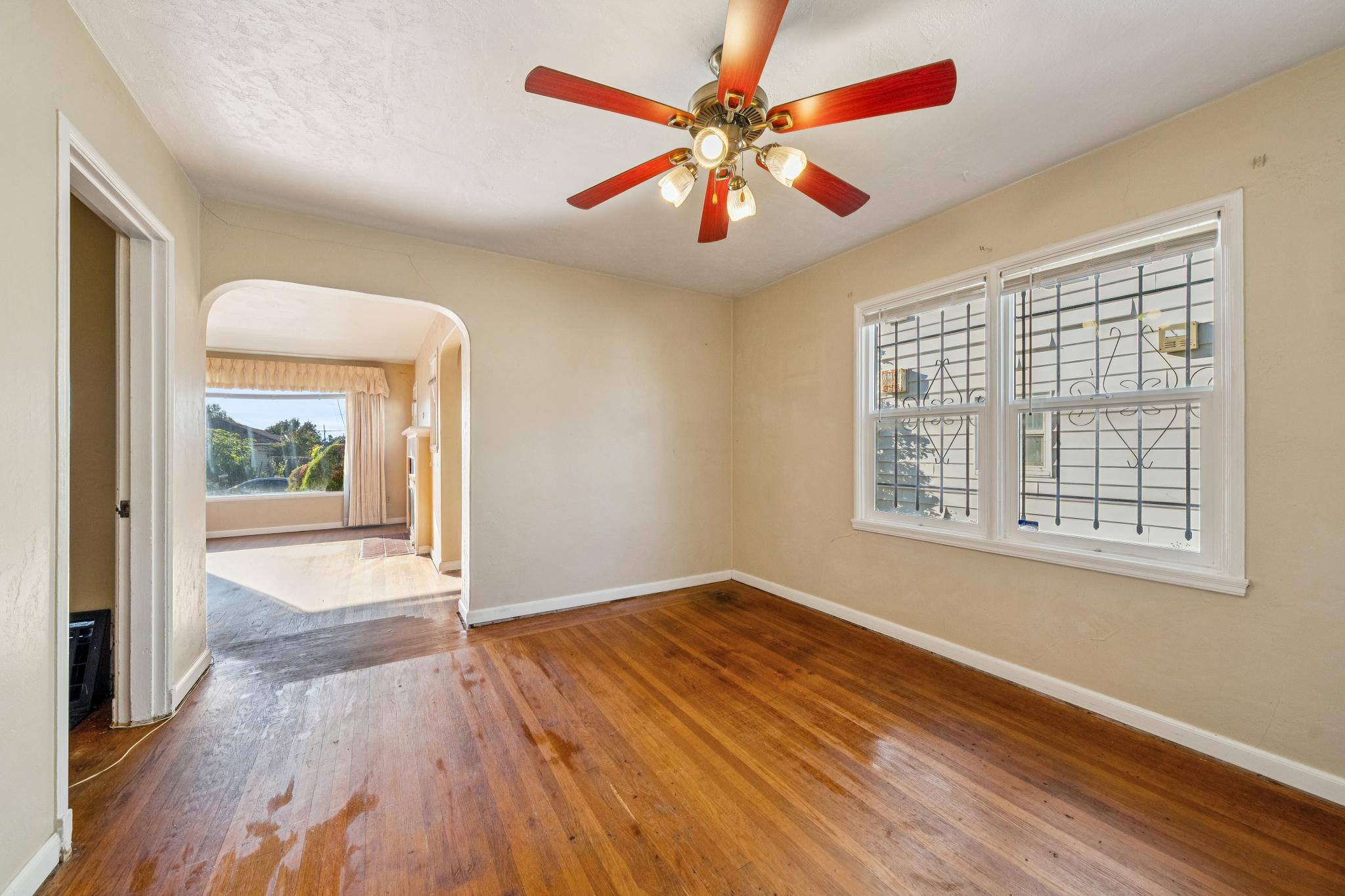 Dining room with hardwood floors, built-in cabinet and arched doorway at 974 33rd St, North and East, Richmond