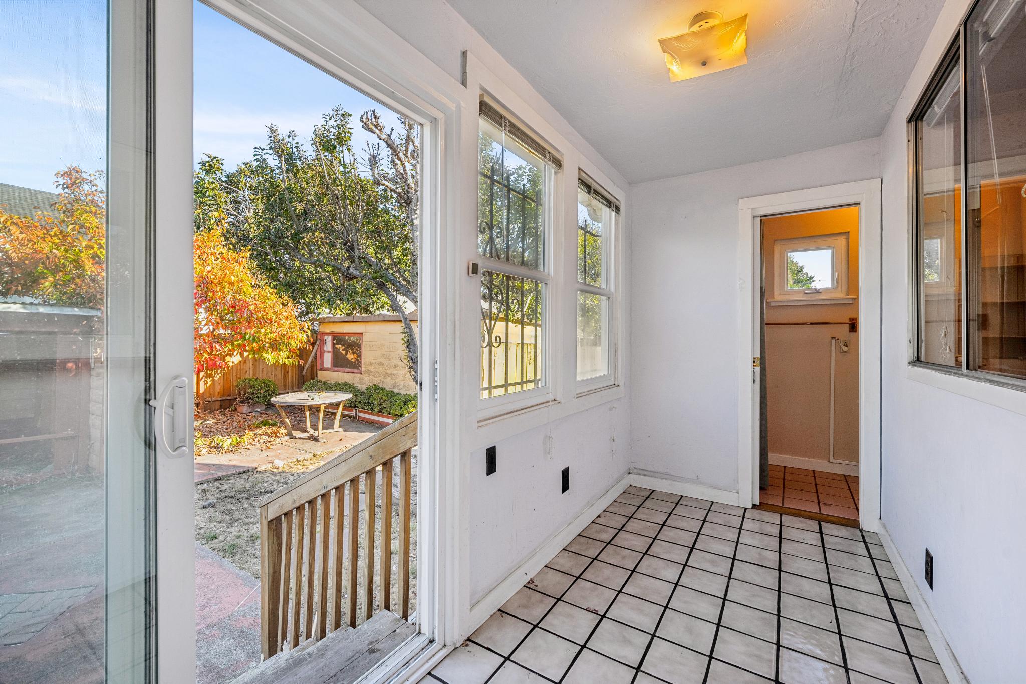Sunroom with windows and a door to the backyard at 974 33rd St, North and East, Richmond