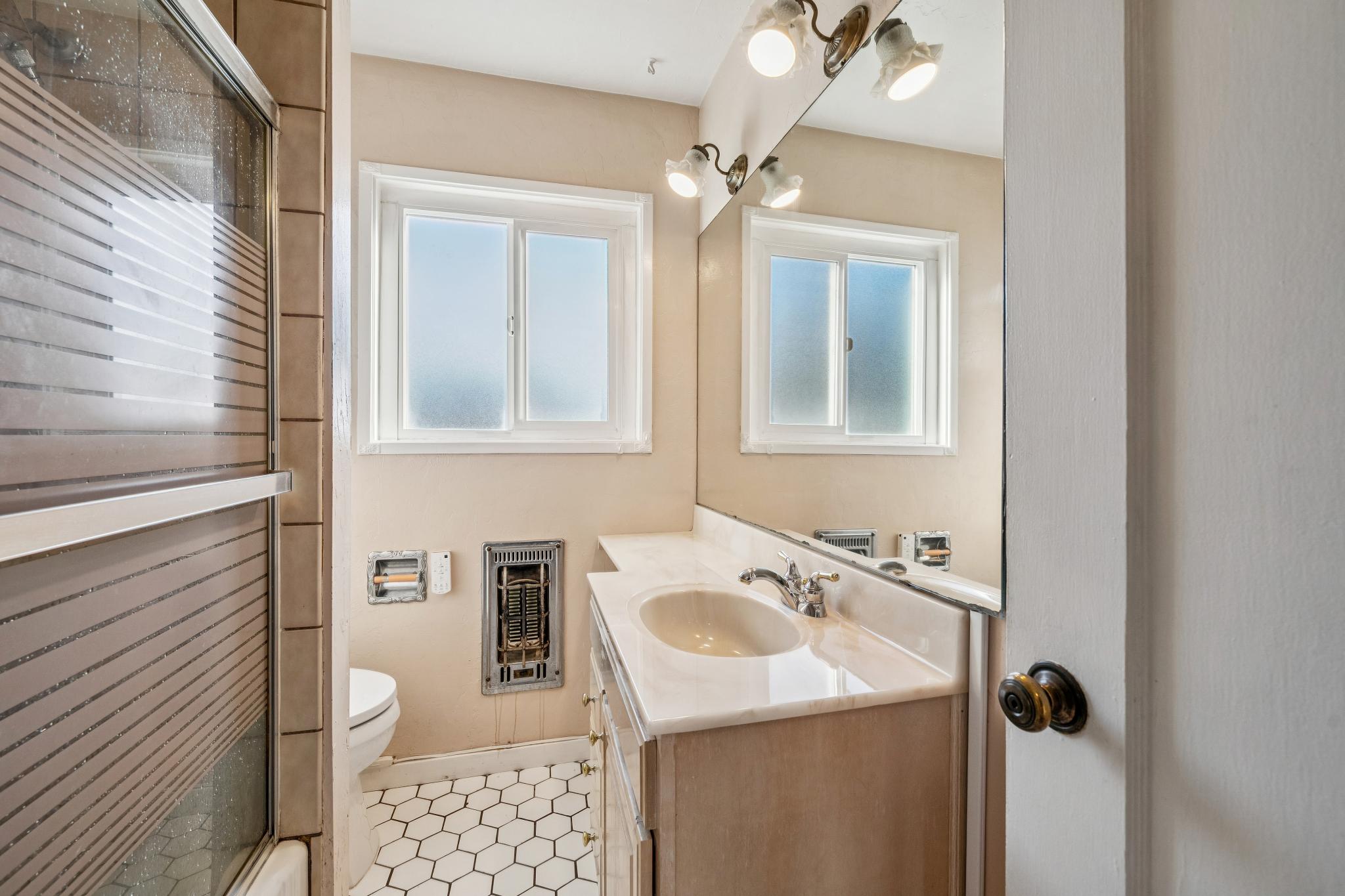 Upstairs bathroom with vanity and window at 974 33rd St, North and East, Richmond