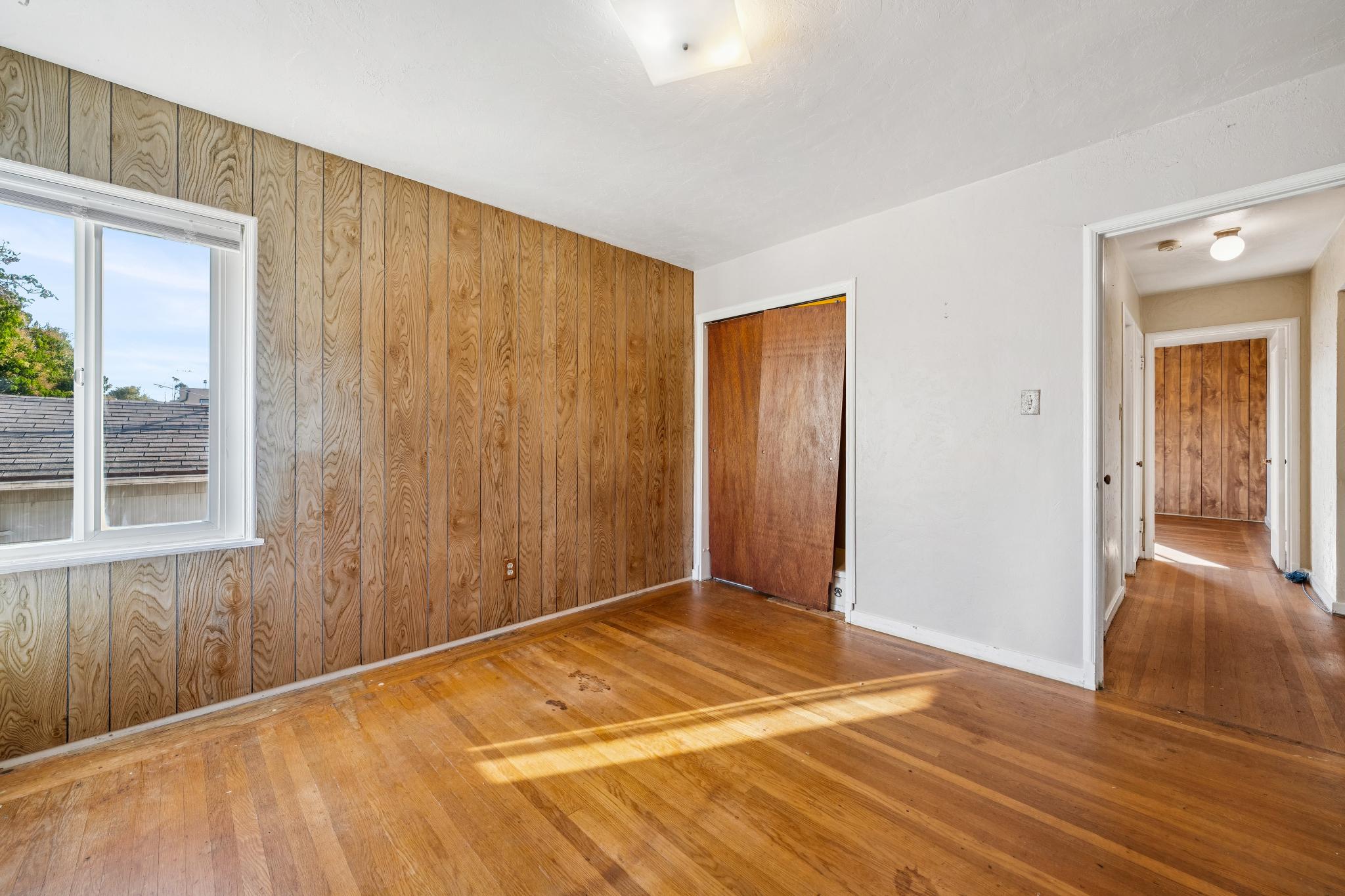 Second upstairs bedroom with wood-paneled walls at 974 33rd St, North and East, Richmond