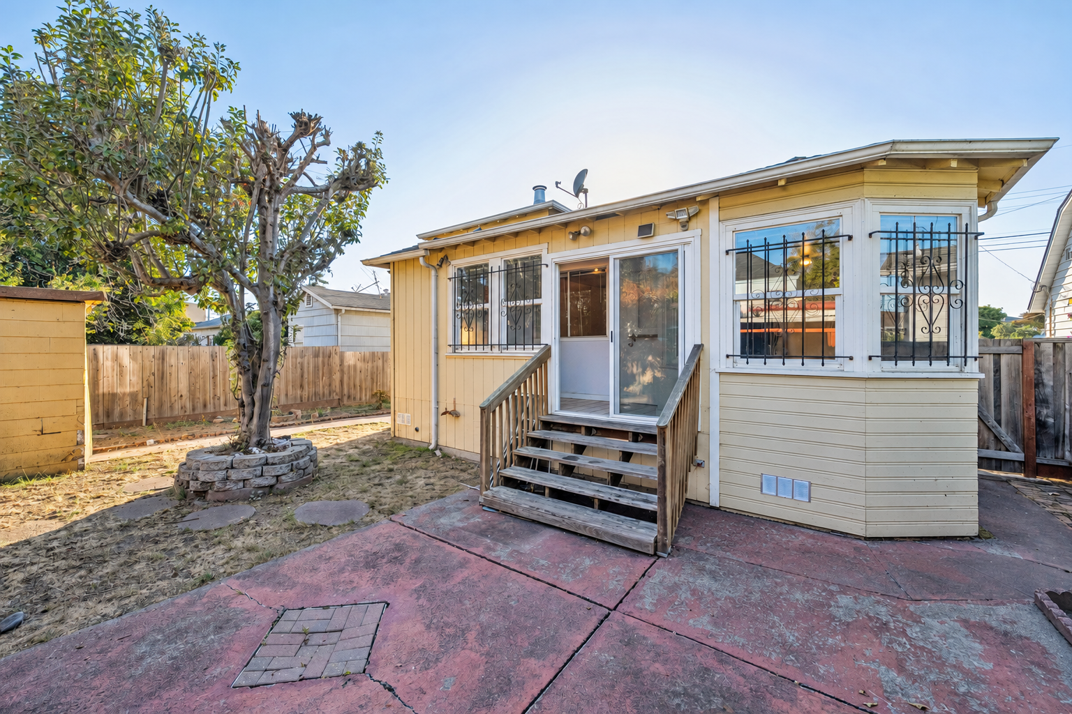 Rear exterior and backyard with sunroom steps at 974 33rd St, North and East, Richmond