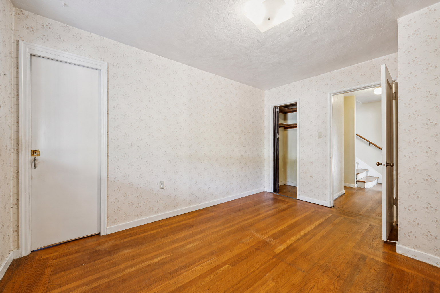 Main-level bedroom with hardwood floors and closet at 974 33rd St, North and East, Richmond